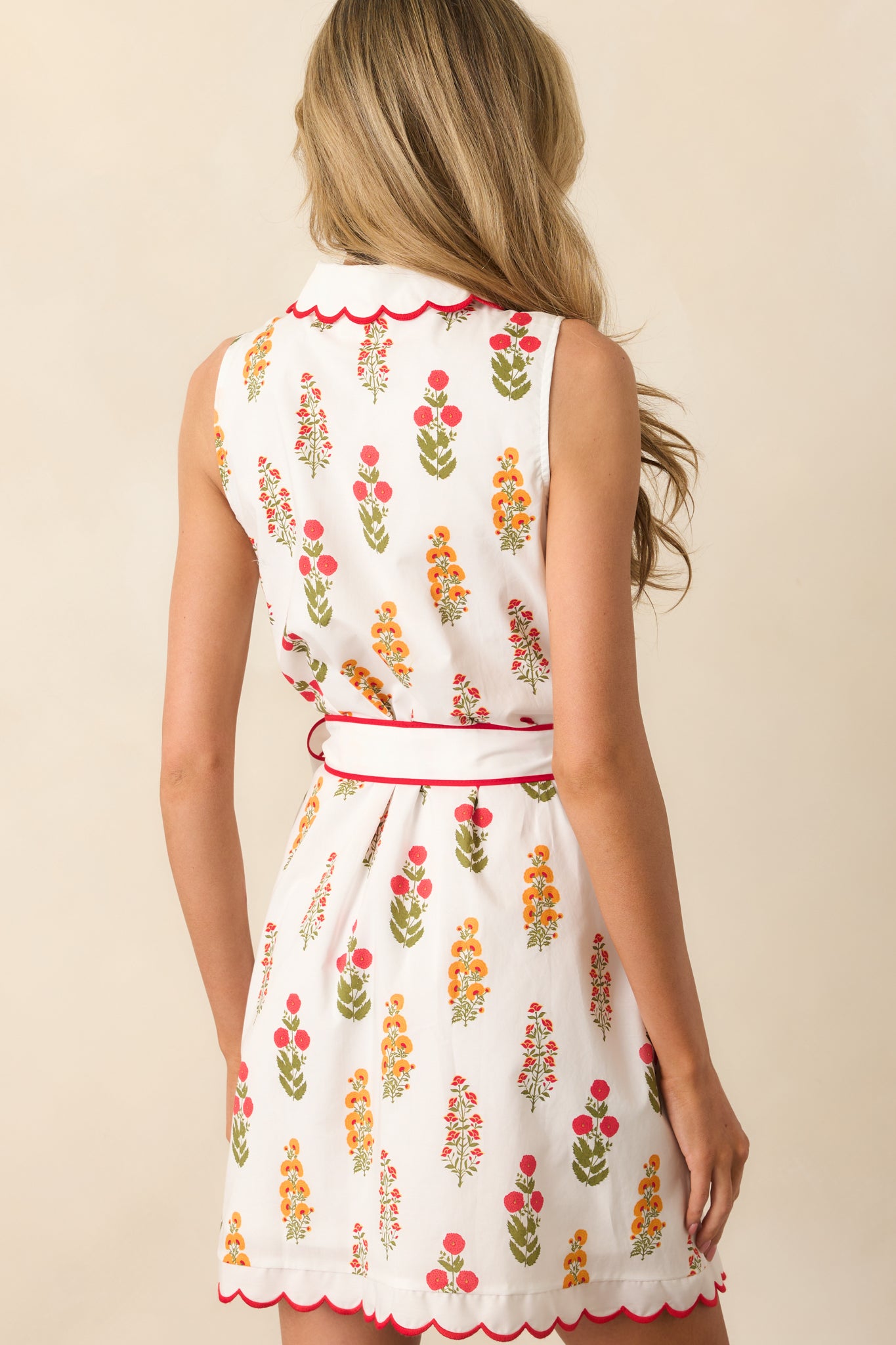 View from behind of the red floral mini dress, displaying the sleeveless cut and continuation of the floral print.