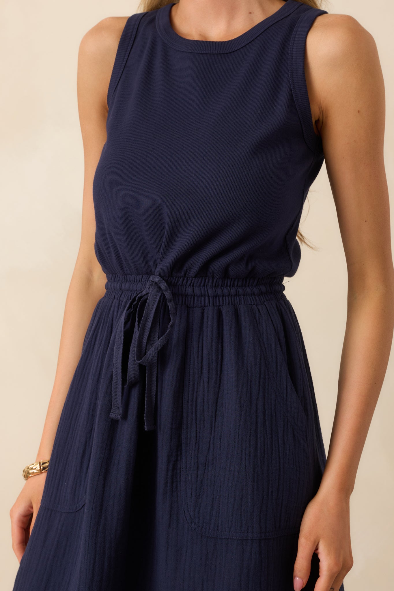 Close-up of the ribbed bodice, drawstring waist, and textured fabric transition between top and skirt.