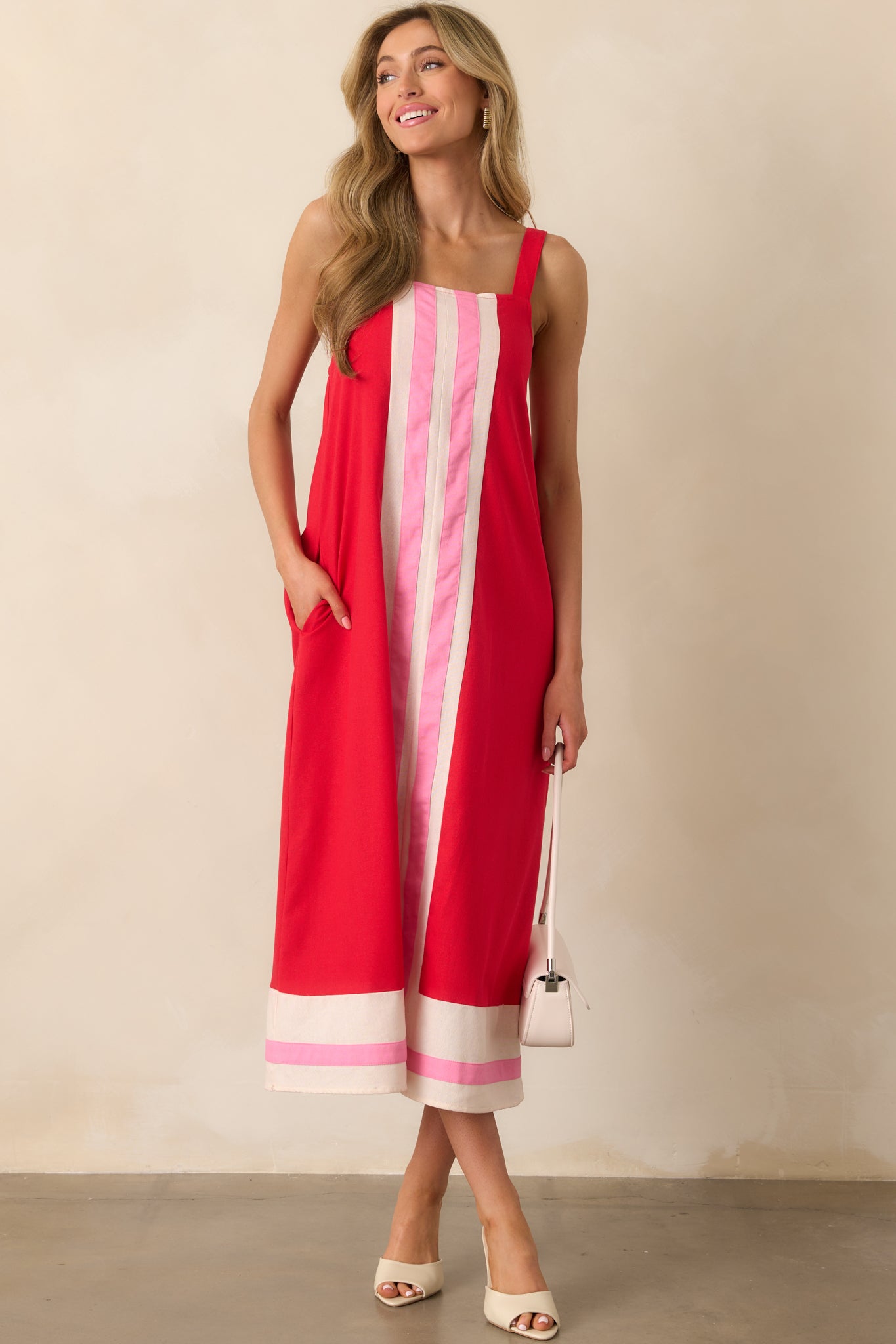 Full-body image of the red dress showing adjustable straps and a flowing, relaxed silhouette.