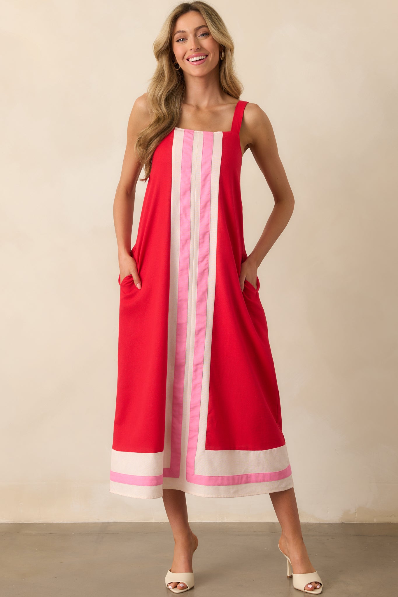 Front-facing shot highlighting the dress’s center stripe design and subtle red lining beneath the outer layer.