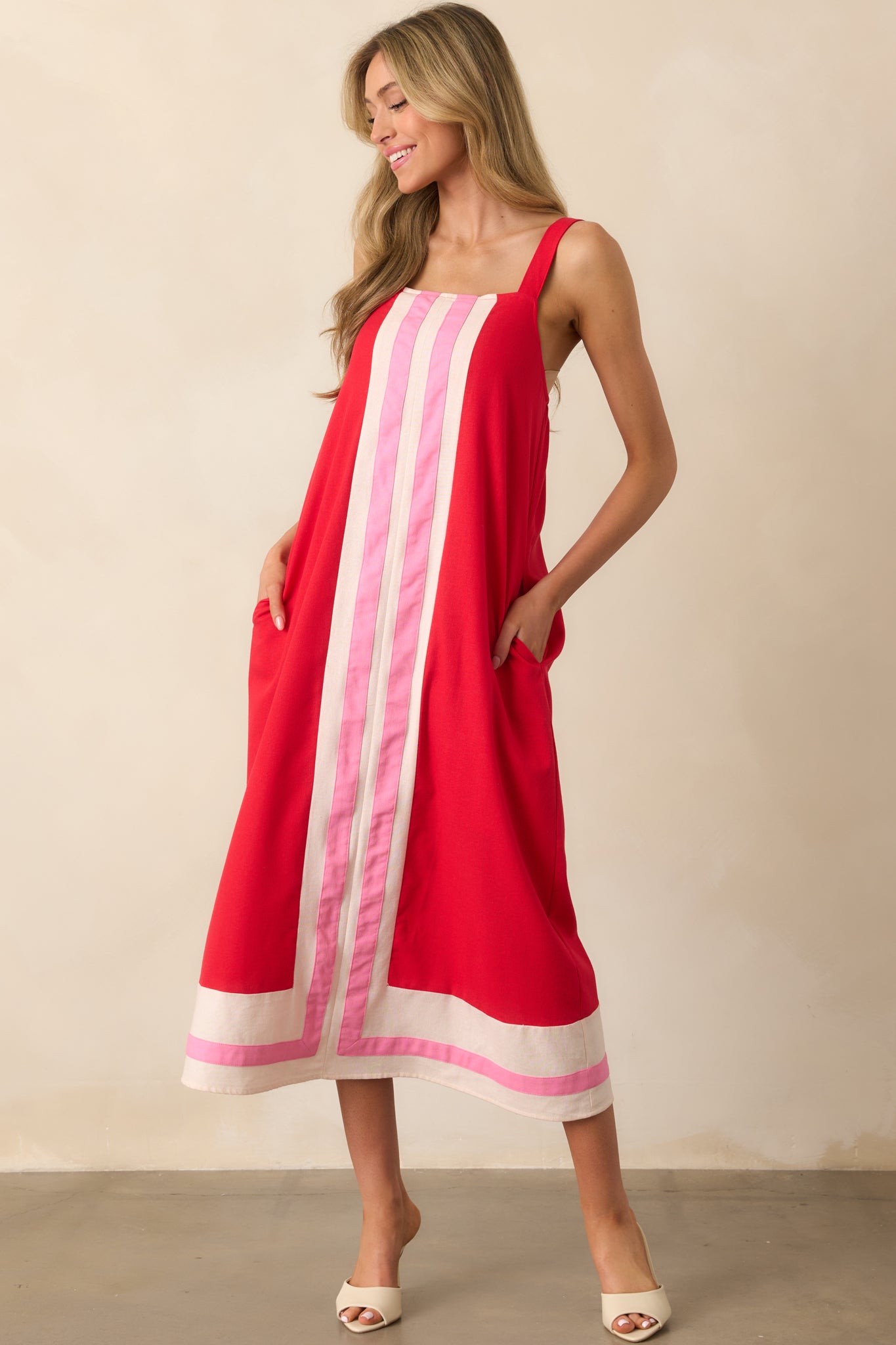 Angled full-body view showcasing the color-blocked hem and the soft drape of the red fabric.