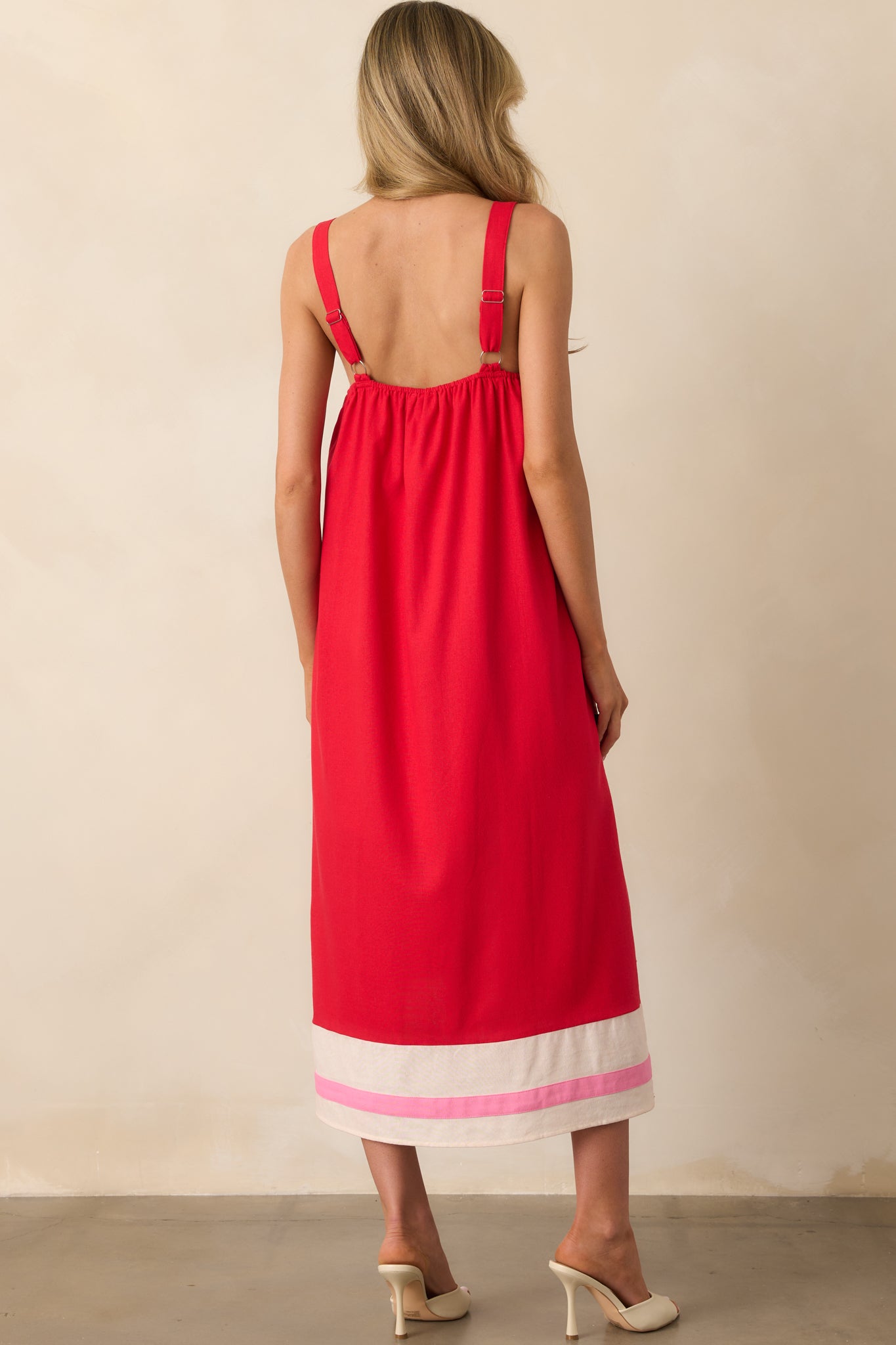 Back view of the red maxi dress showing the elasticized top hem insert and continuation of the stripe design.
