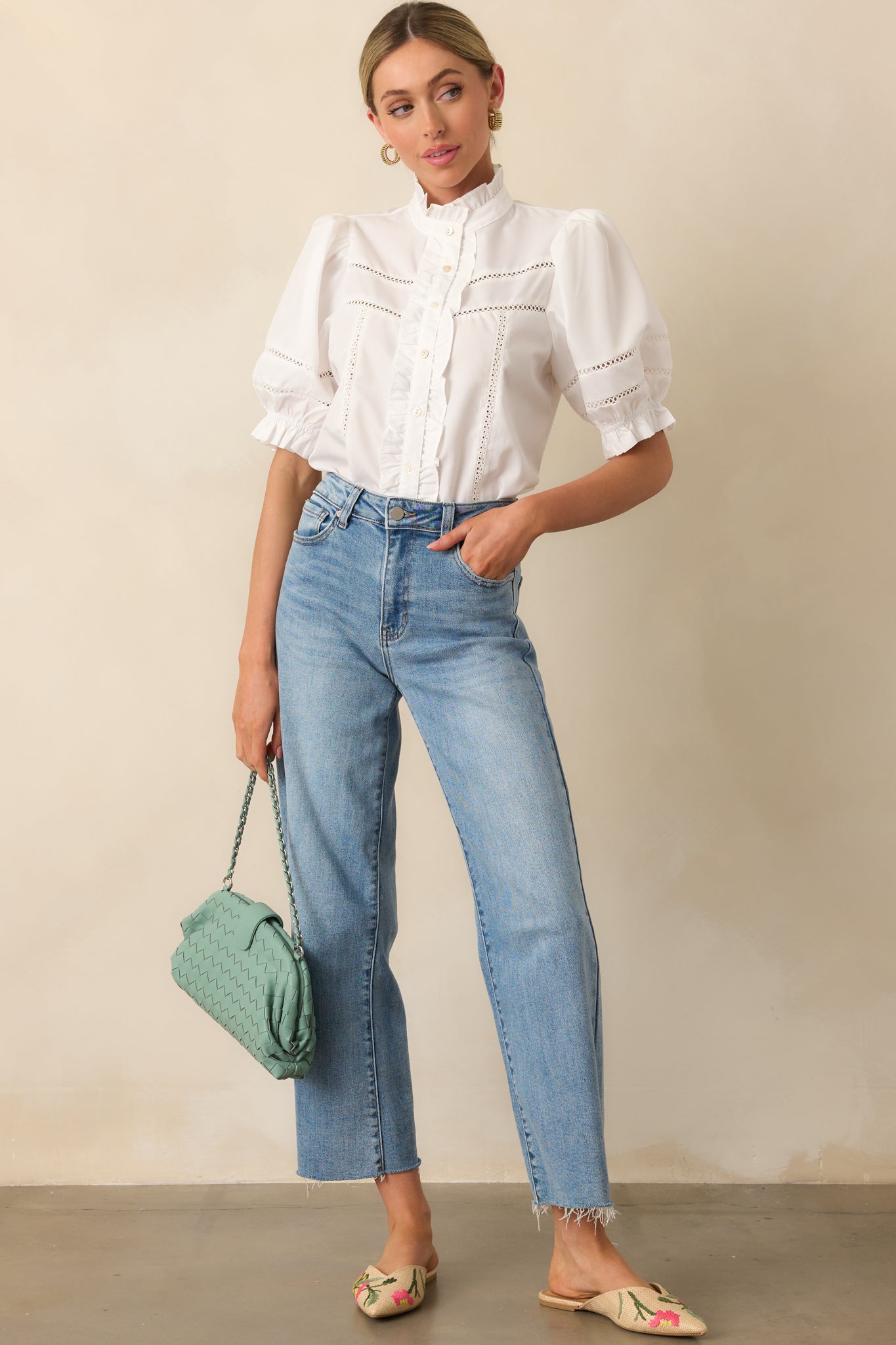 Full front view of ivory button-up top featuring layered ruffle trim along the neckline and sleeve edges.