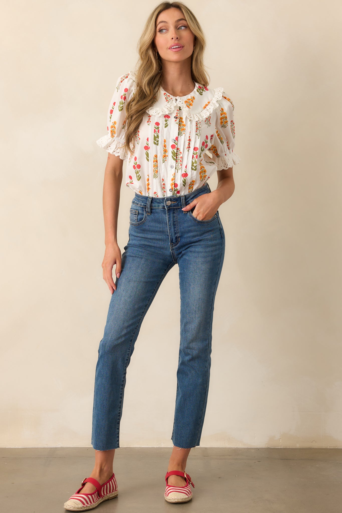 A front-facing shot of the top with a peter pan collar, short puff sleeves, and delicate lace trim, offering a soft and feminine look.