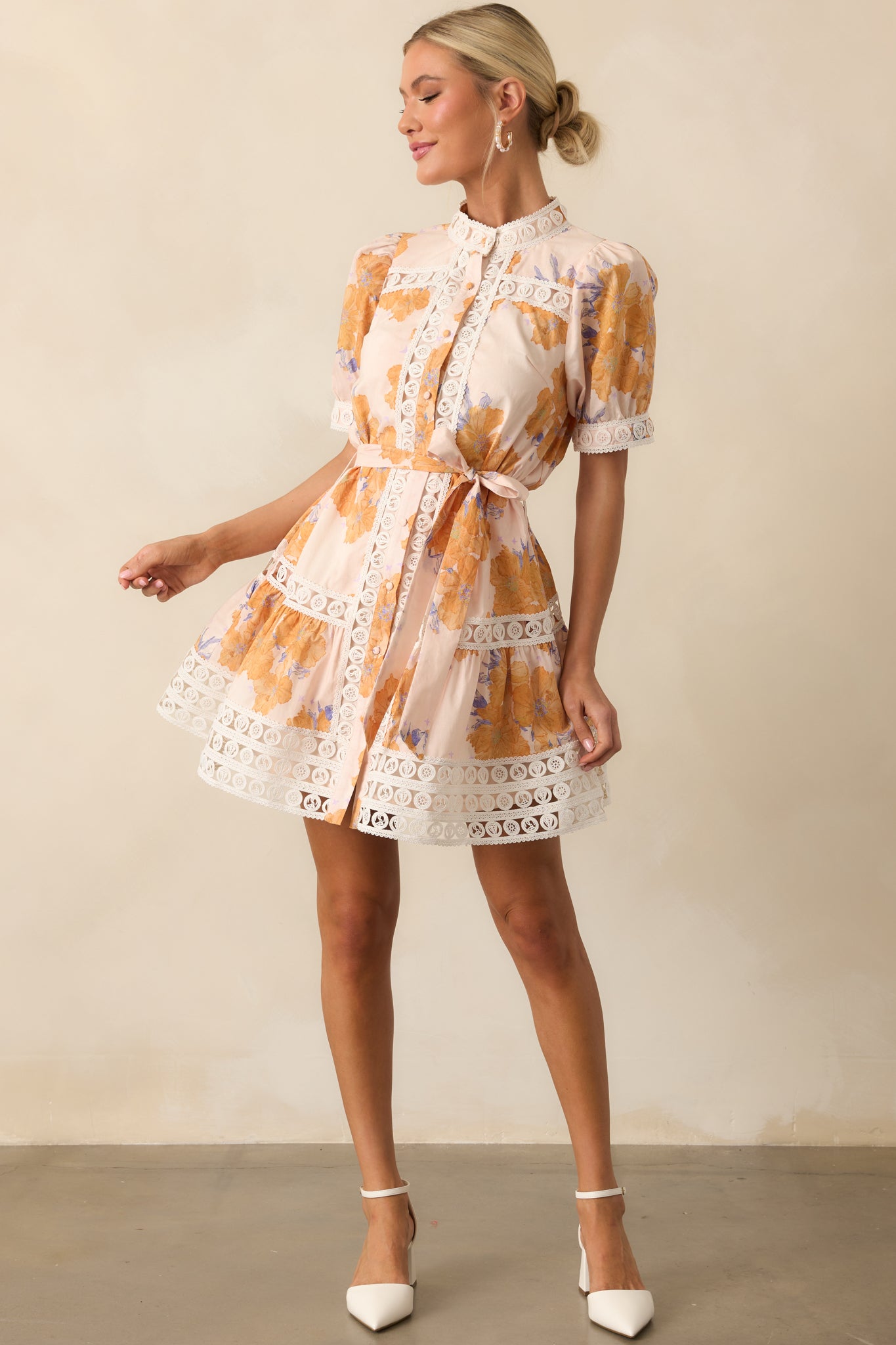 Full-length image of the honey yellow dress displaying the ivory lace trim details and mini hemline.