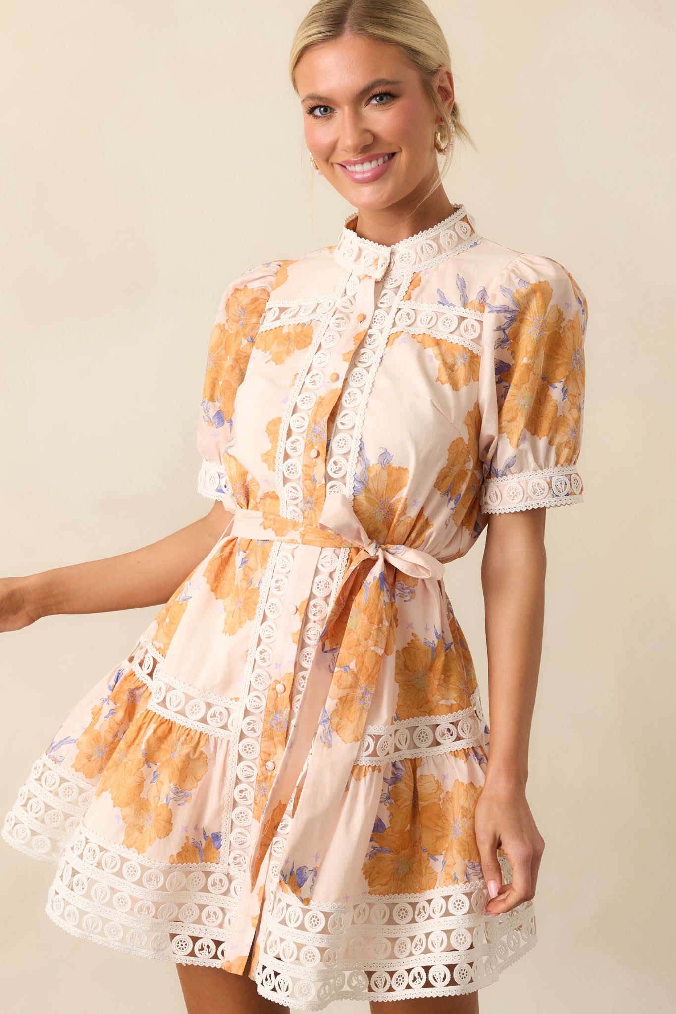 Cropped image focusing on the hem of the mini dress and the ivory lace trim detail.