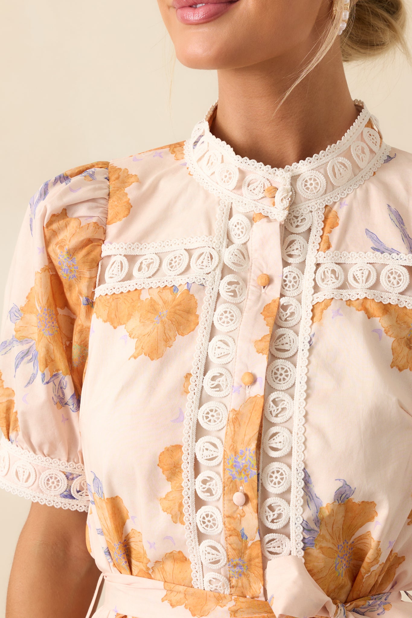 Close-up of the honey yellow dress showcasing the texture of the fabric and intricate lace trim stitching.