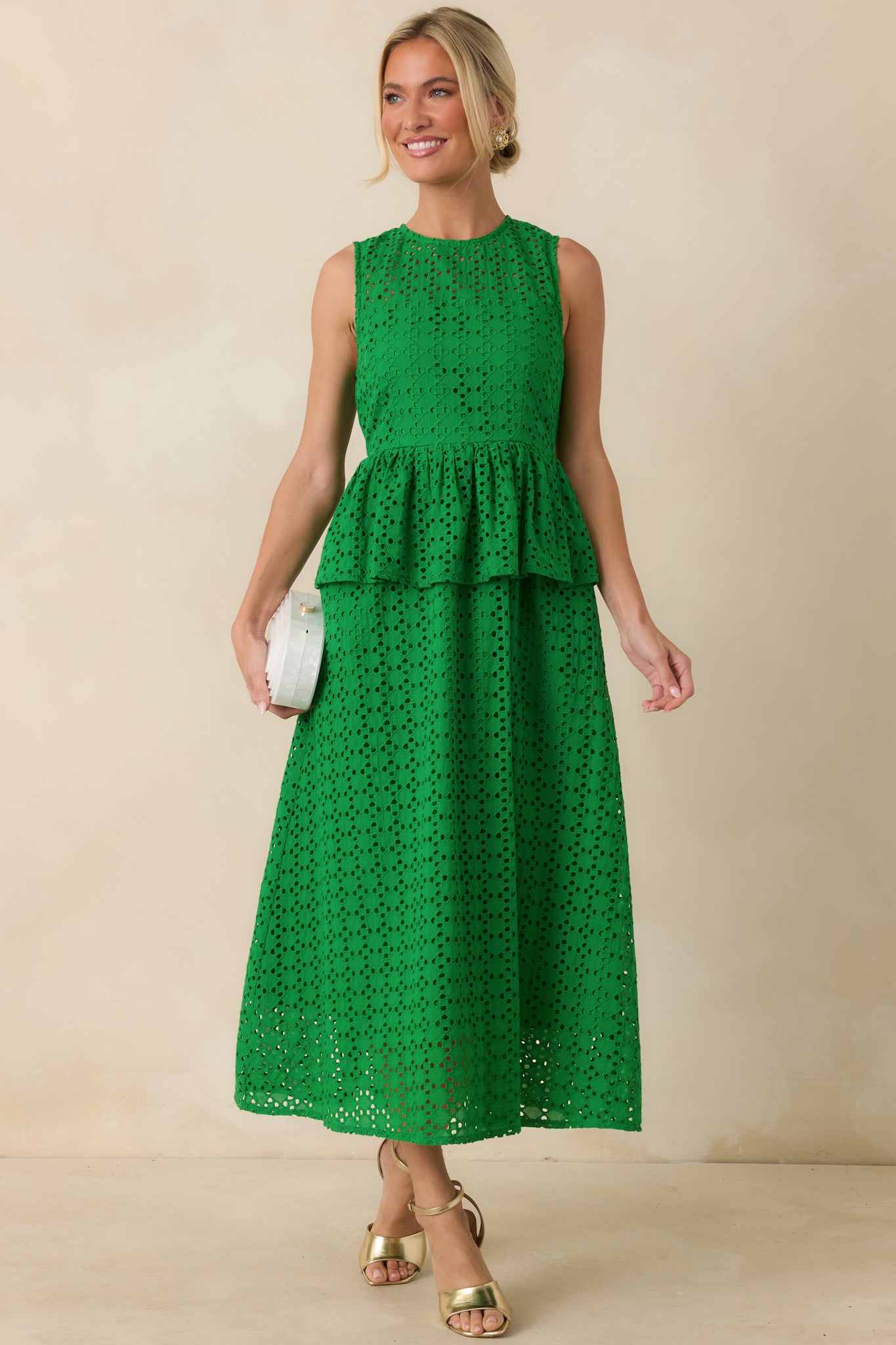 Green midi dress with intricate eyelet patterning, side pockets, and a softly flared skirt for an airy shape.