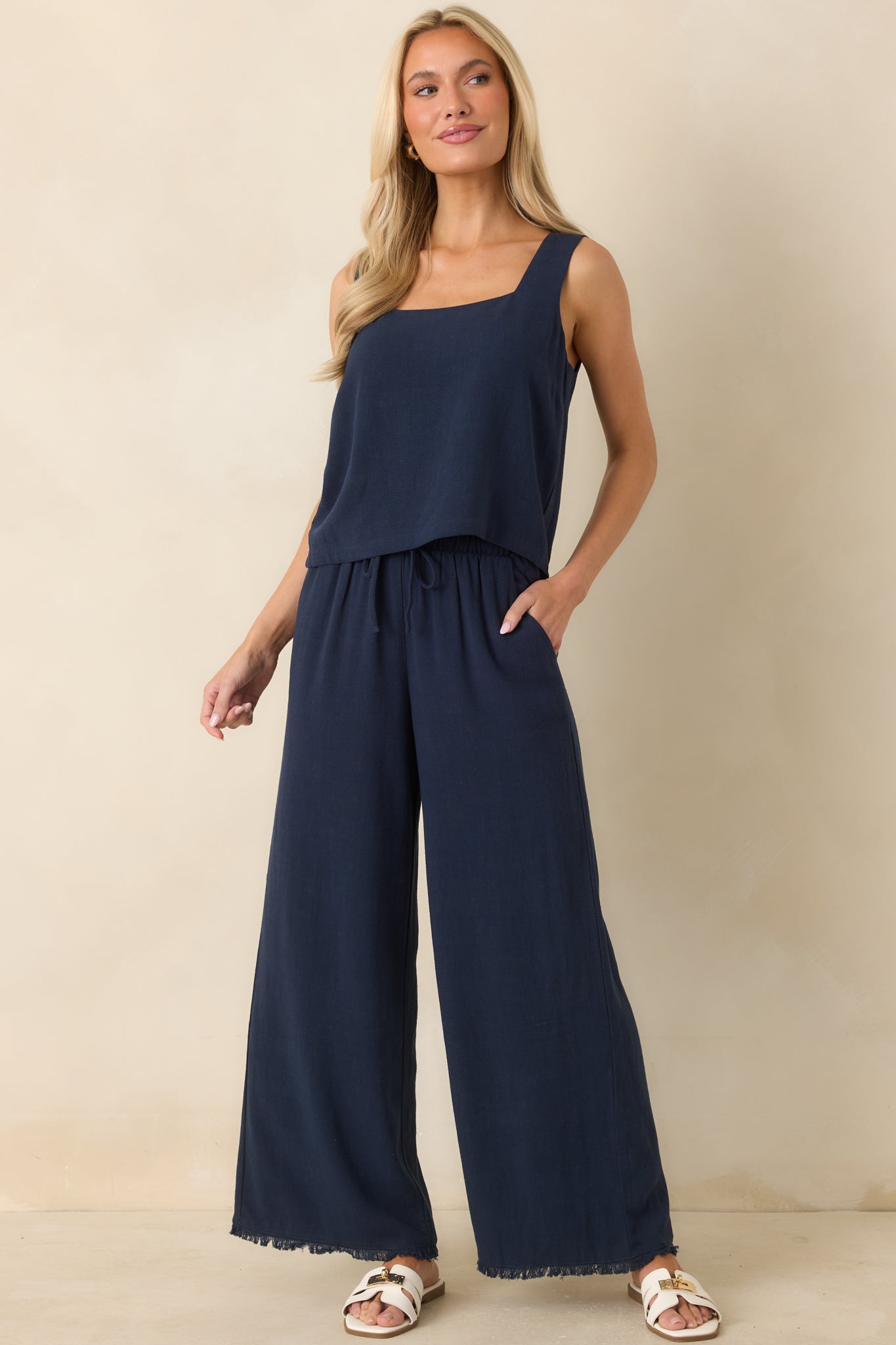 Navy cropped tank in a lightweight linen blend featuring a square neckline and sleeveless silhouette with a relaxed, breathable drape.