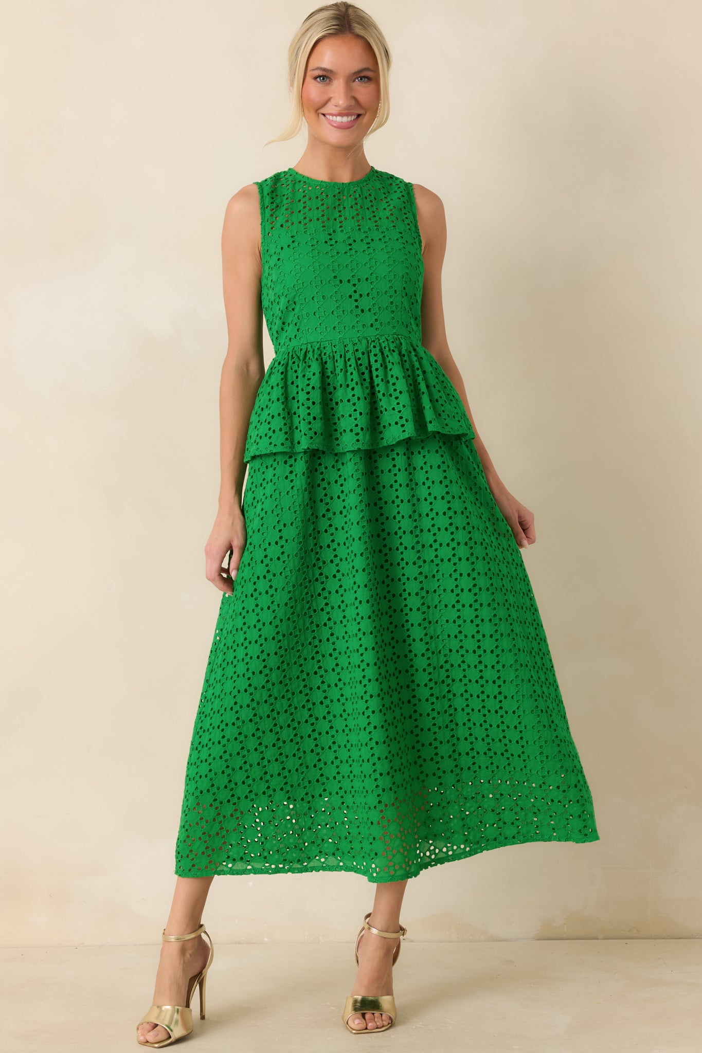 Cotton eyelet dress featuring a fitted upper shape, peplum waist accent, and lightweight breathable structure.