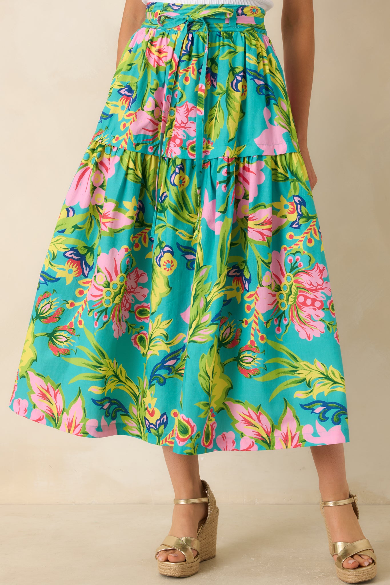 Close view of the jade skirt highlighting the elastic waistband and tropical floral print detailing.