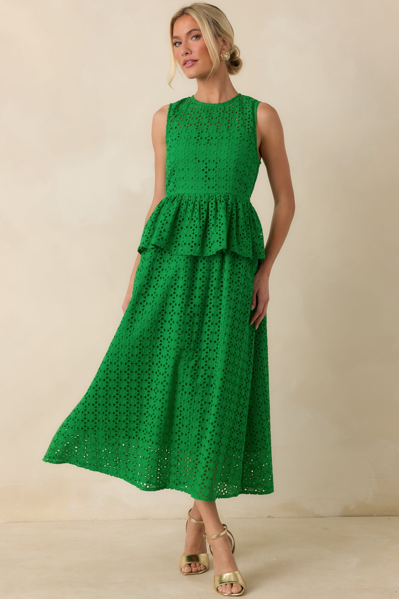 Green 100% cotton eyelet midi dress featuring a round neckline, sleeveless silhouette, and allover eyelet detailing.