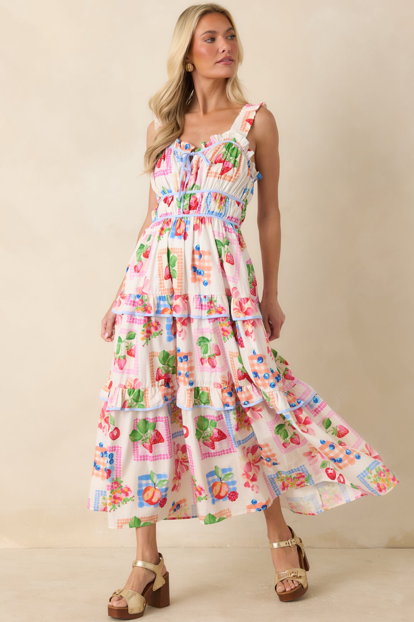 Multi-color floral and fruit print dress with ruffled straps, side pockets, and a relaxed yet structured maxi fit.