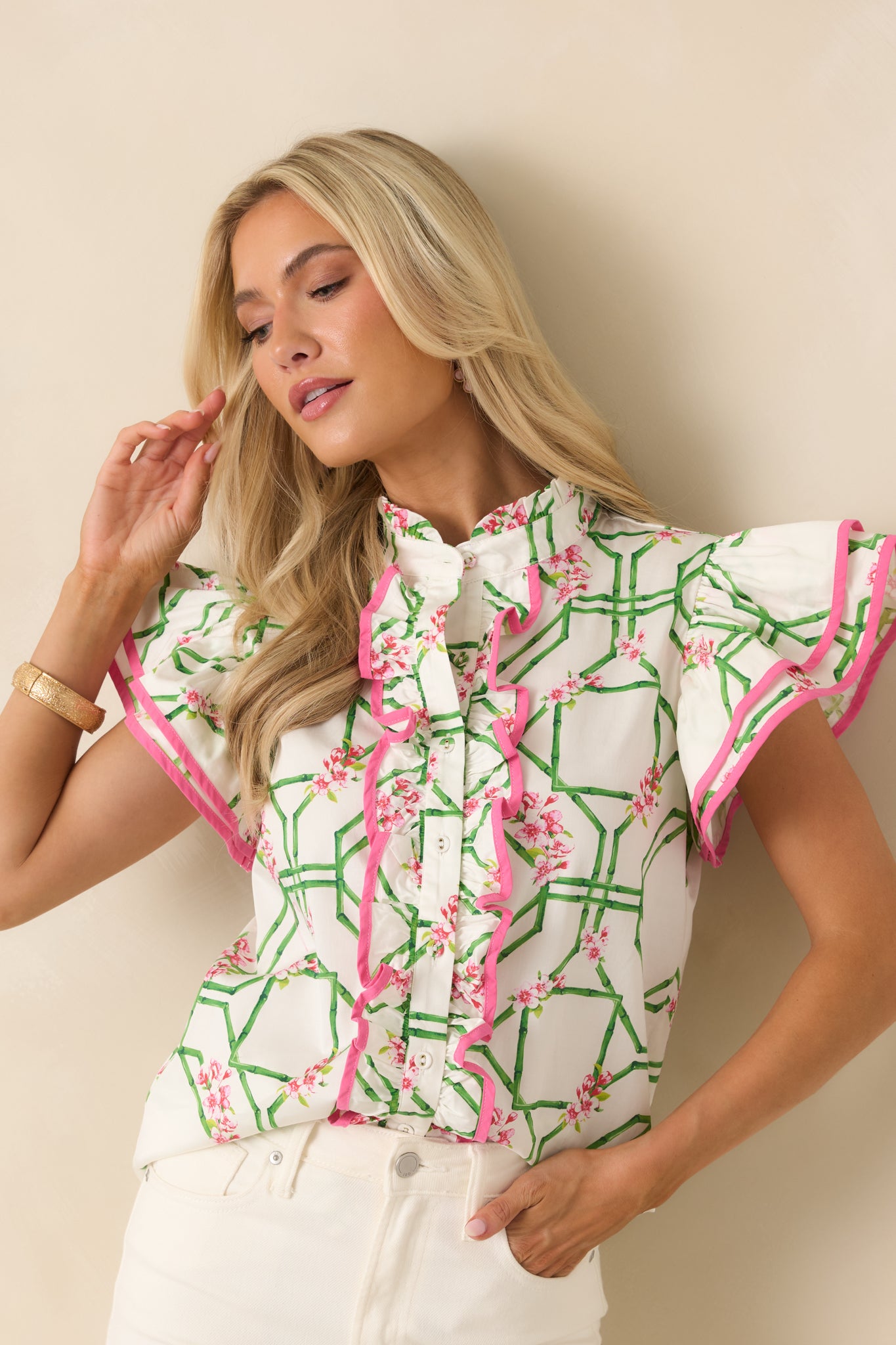 Cropped detail of flutter sleeves showing contrast trim accents and soft cotton texture.