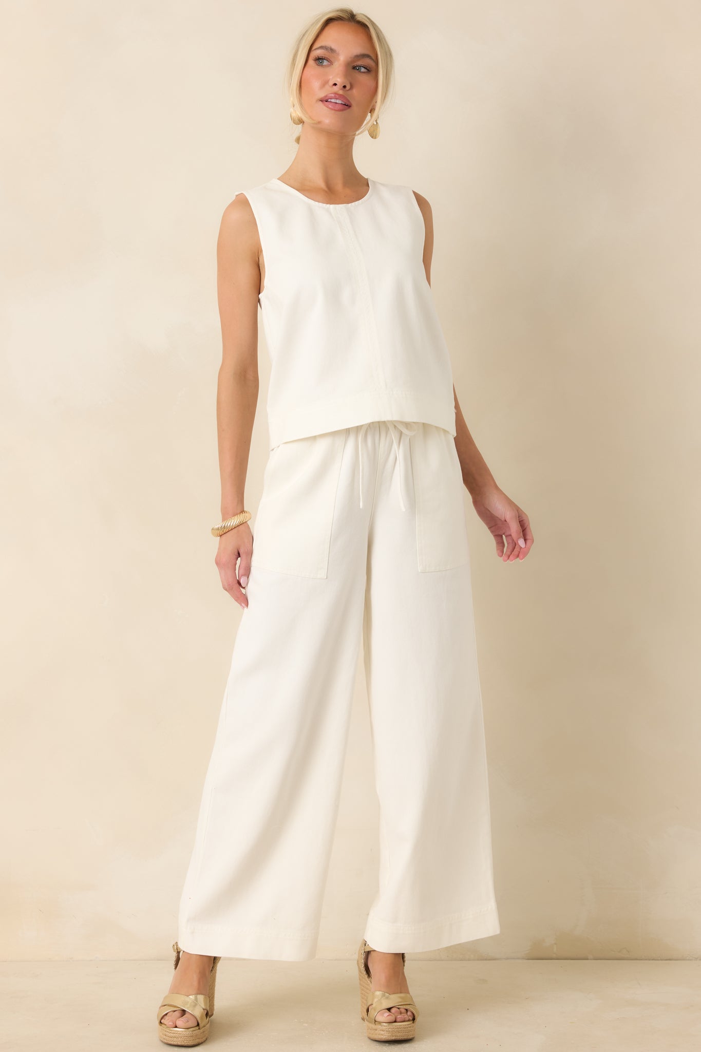 Full-length look showcasing the wide-leg cut and easy, airy movement through the legs in a clean ivory tone.