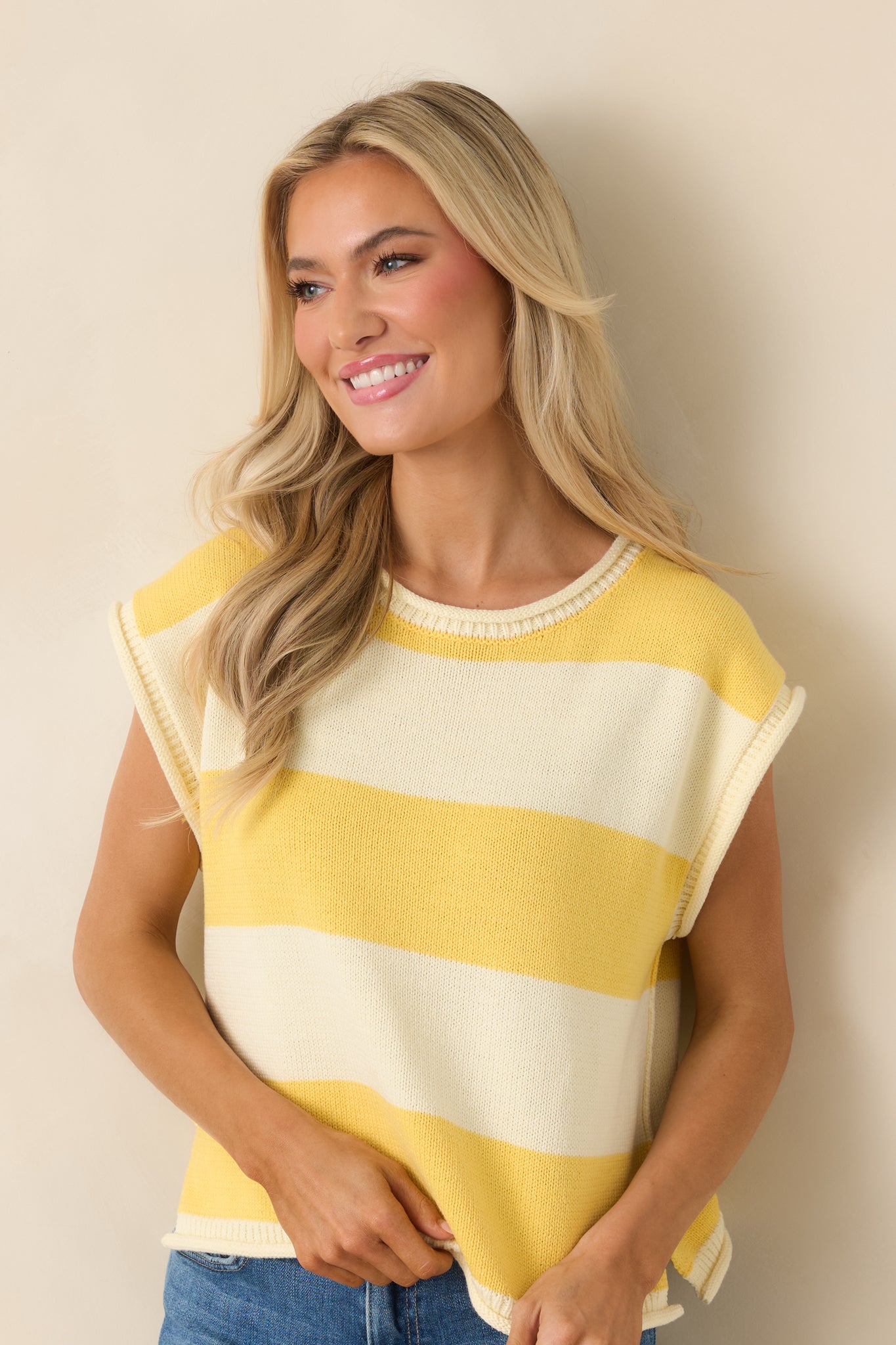 Striped knit top featuring cap sleeves and relaxed polished silhouette.