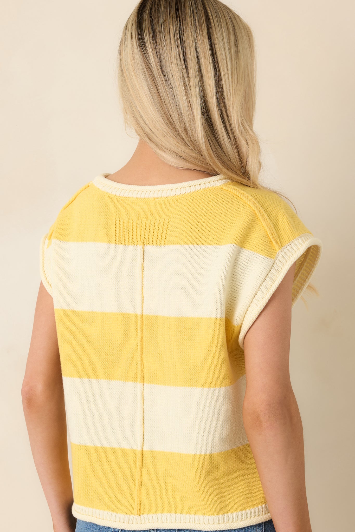 Rear view of striped knit top with round neckline and cap sleeves