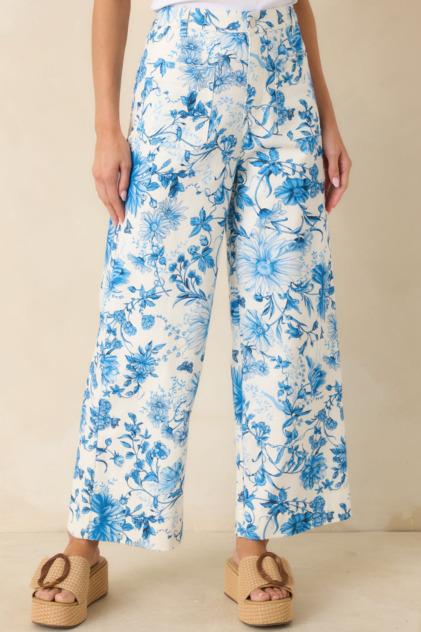 Close view of waistband with button and zipper closure and belt loop detailing.