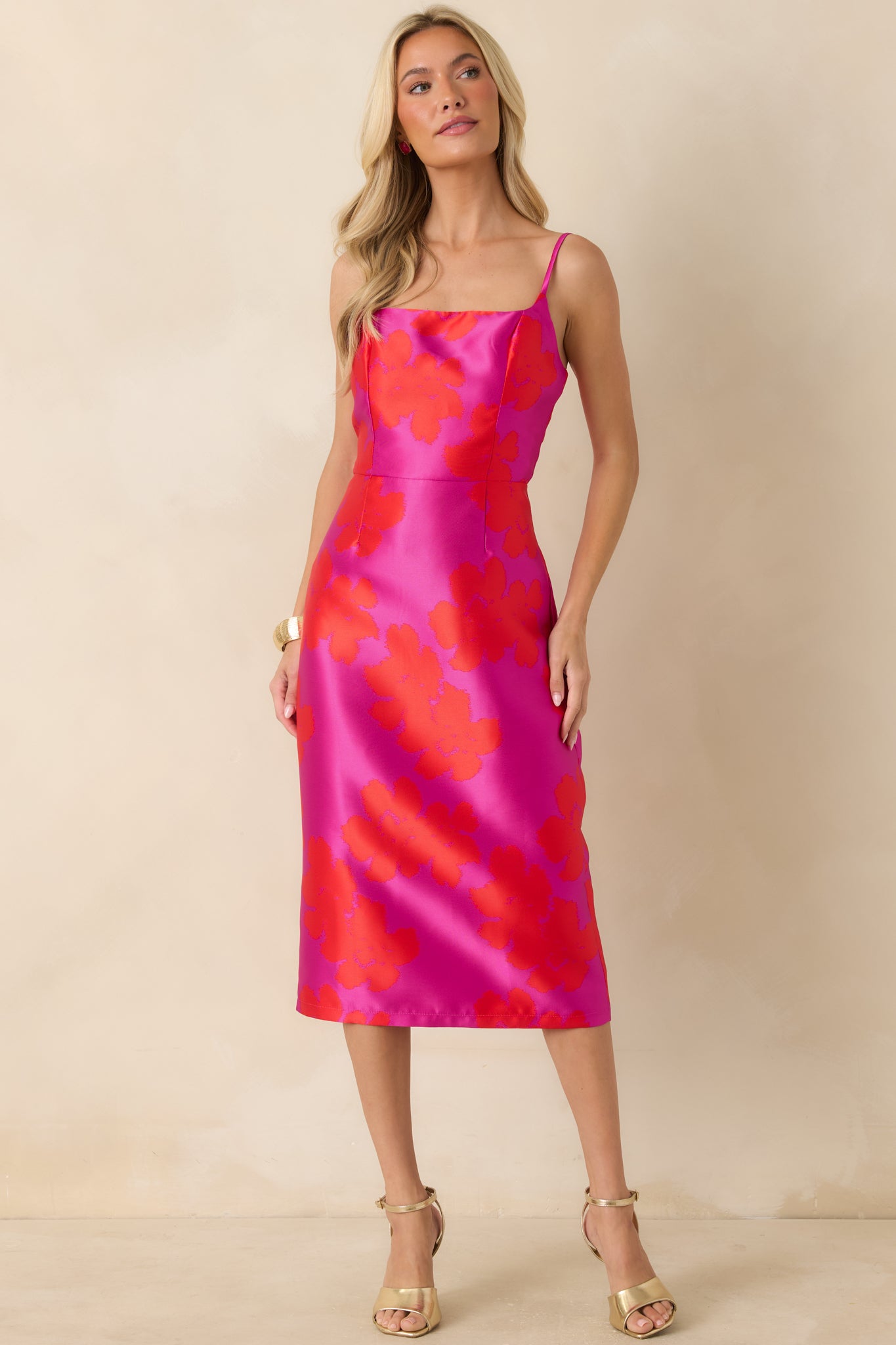 Fuchsia and red midi dress featuring a floral jacquard weave, adjustable spaghetti straps, and a fitted, body-skimming silhouette.