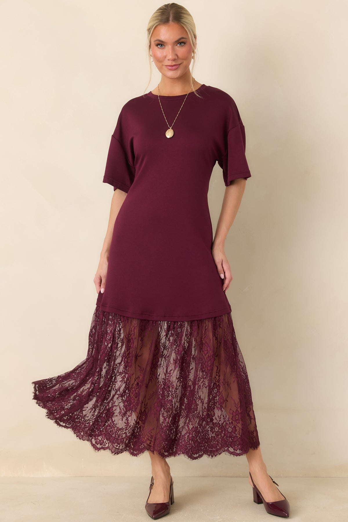 A relaxed knit bodice with dropped shoulders transitions into a sheer floral lace skirt on this plum midi dress.