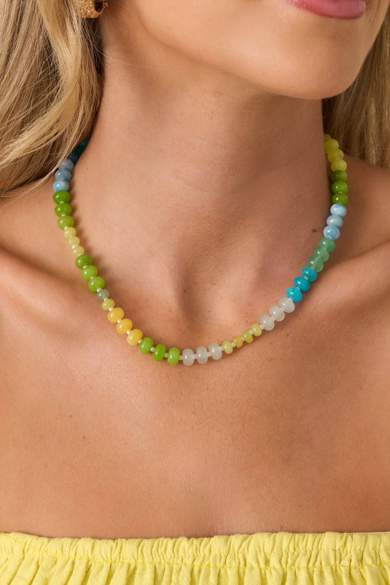 Colorful beaded necklace featuring a mix of green, aqua, blue, and yellow glass beads with a lightweight everyday design.