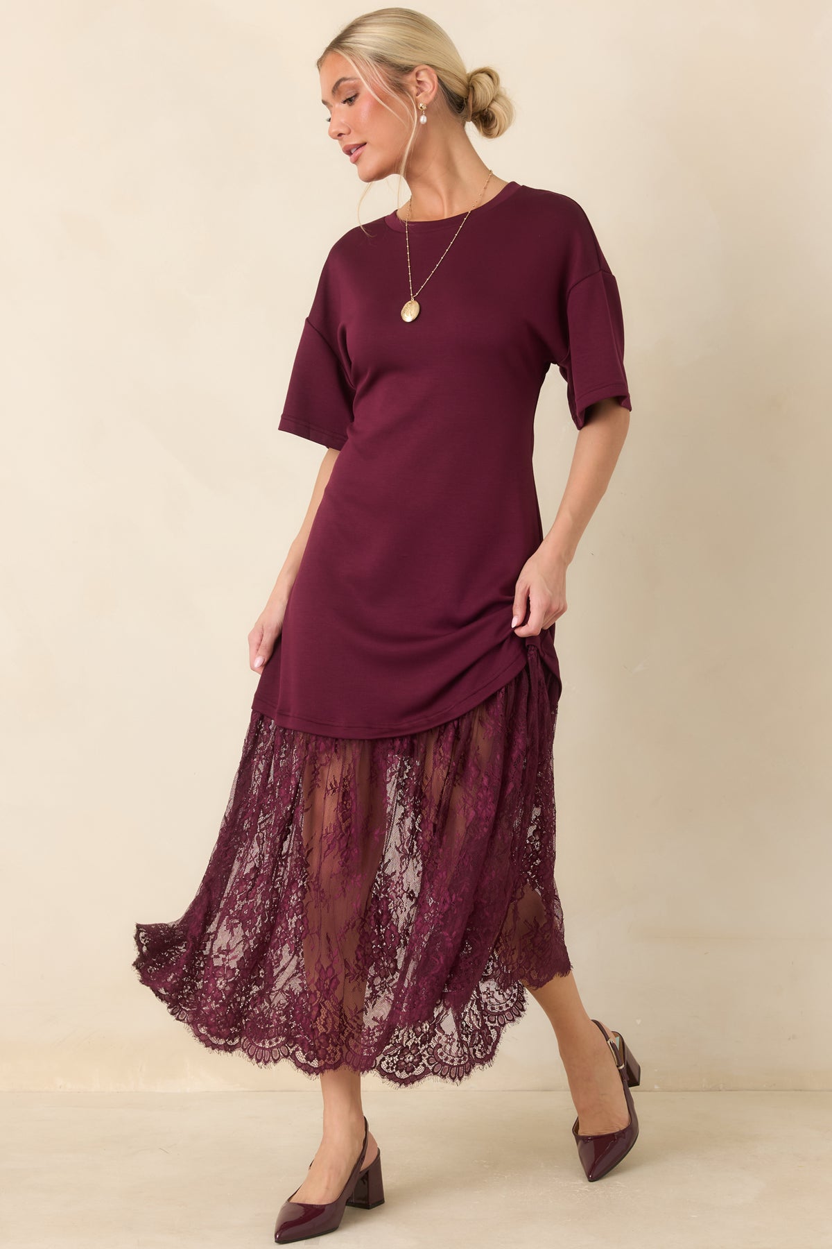 Plum midi dress with a smooth knit bodice, crew neckline, relaxed short sleeves, and a sheer floral lace skirt.