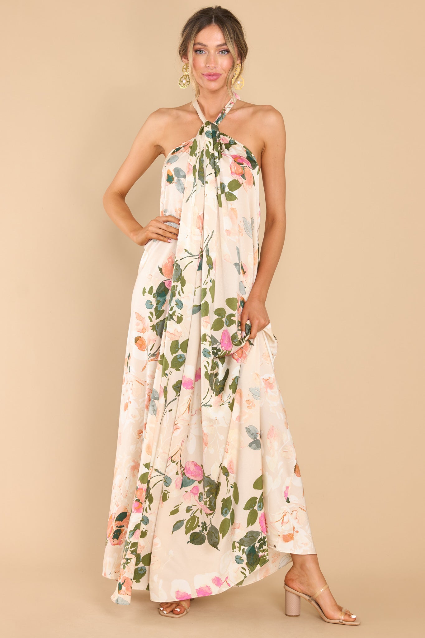 Front view of this dress that features a high neckline with keyhole cutouts and halter self tie around the neck, open back, elastic along lower back seam, and a flowy fit throughout.