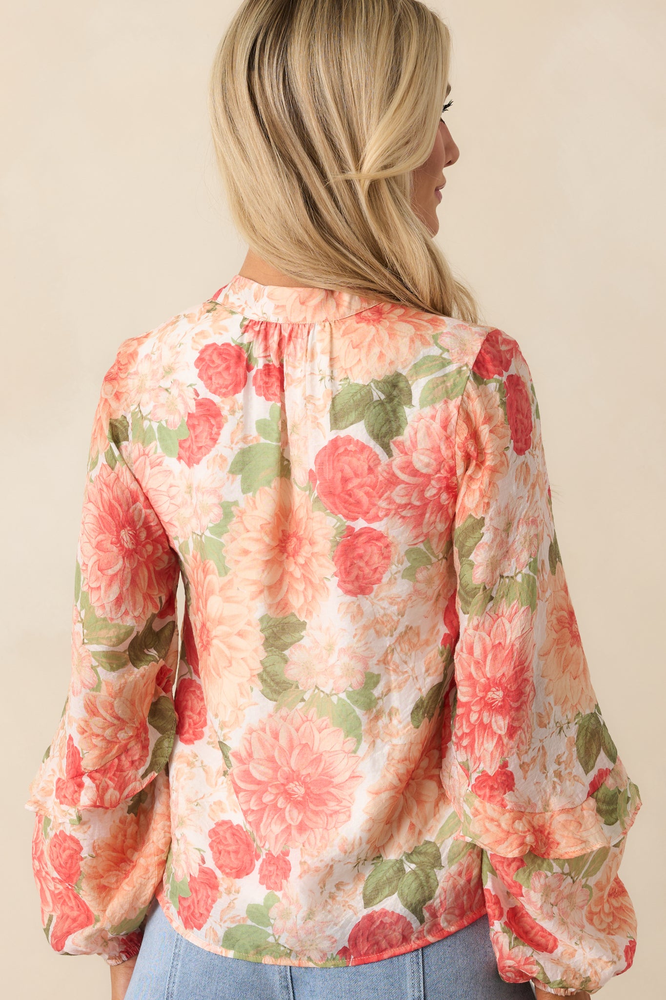 A complete back view of the blouse showing the flowy silhouette and continued floral pattern.