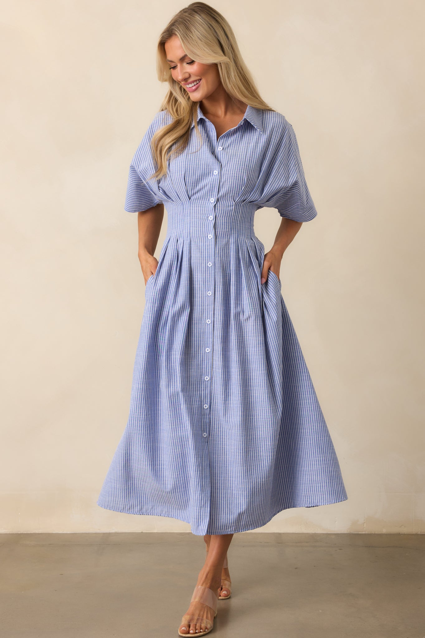 Front view of a blue midi dress with a collared neckline, short sleeves, and vertical stripe pattern.
