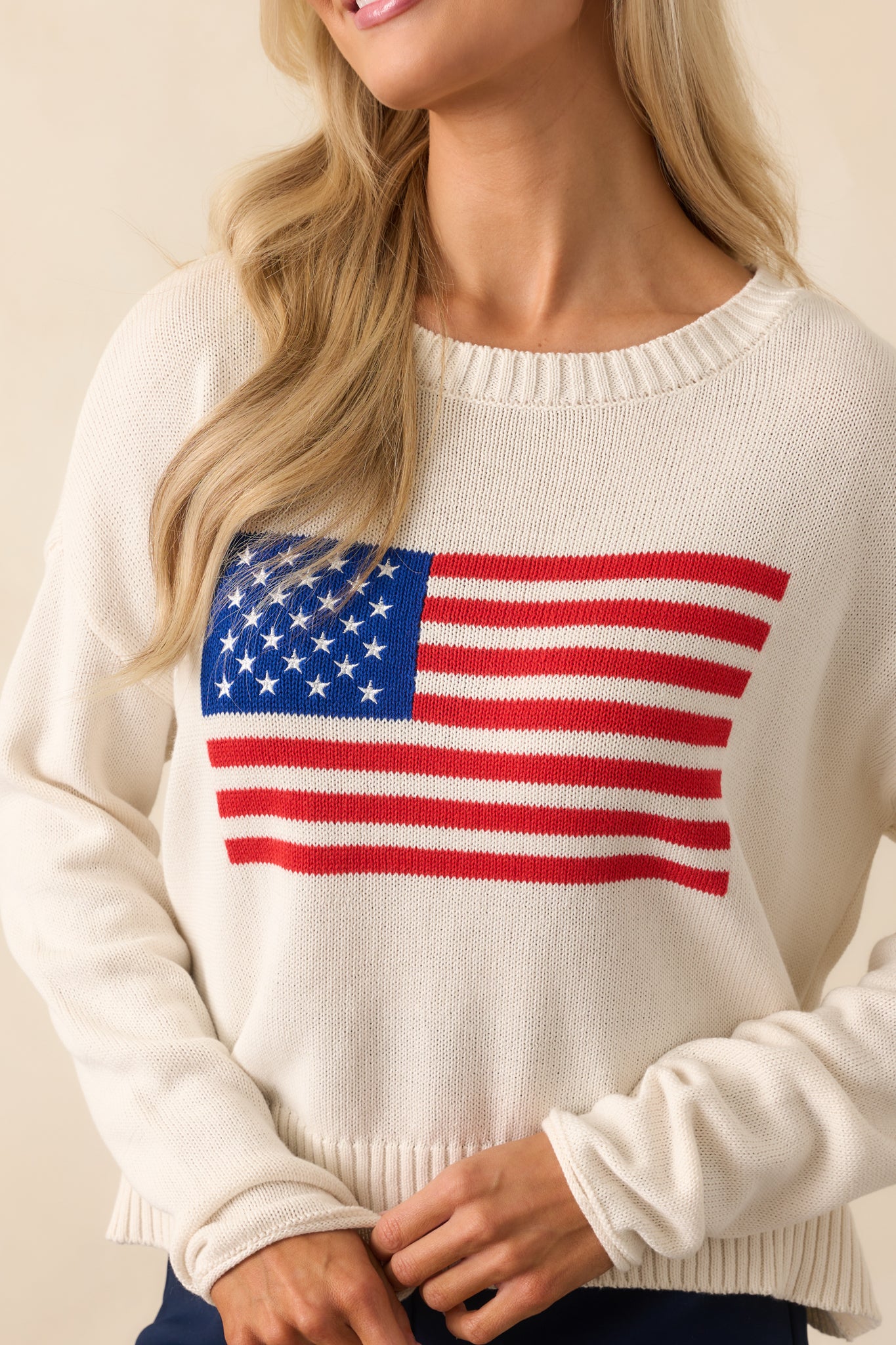 Close-up of the embroidered USA flag across the chest, showing intricate stitching and knit texture.