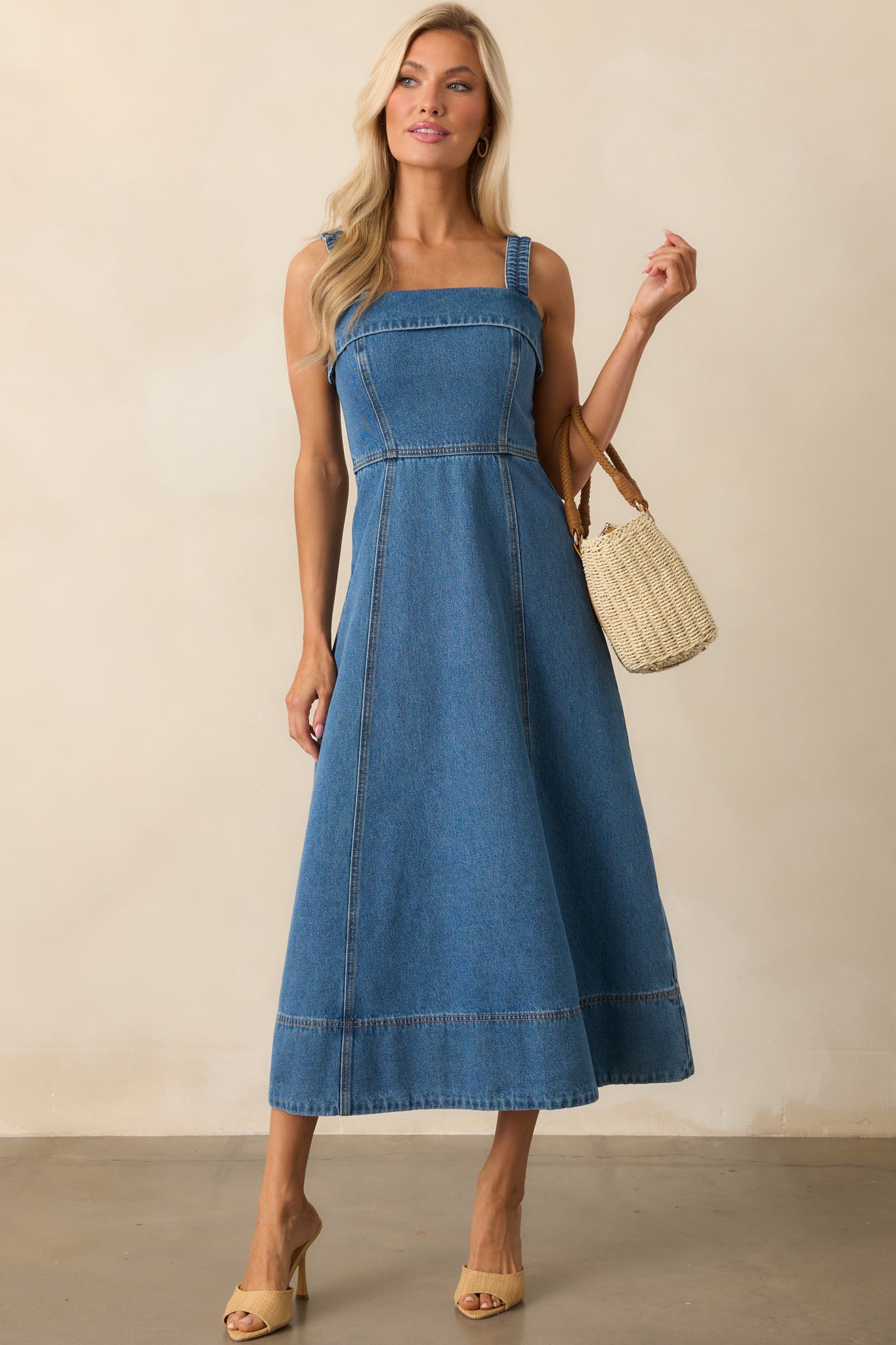 Full-length image emphasizing the clean vertical paneling and soft flare of the midi-length skirt.