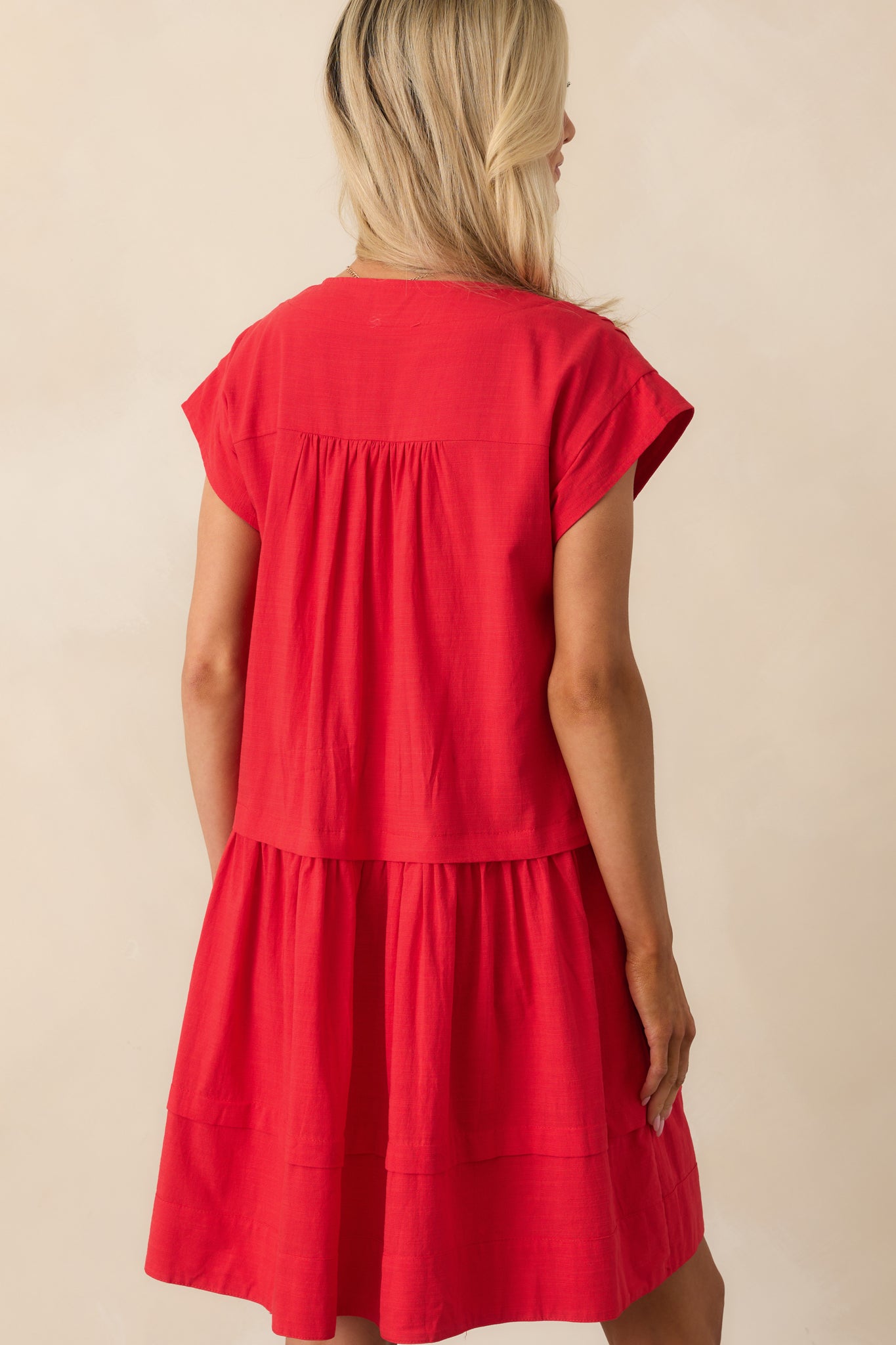 A view from behind showing the dress’s relaxed shape and soft tiering through the skirt.