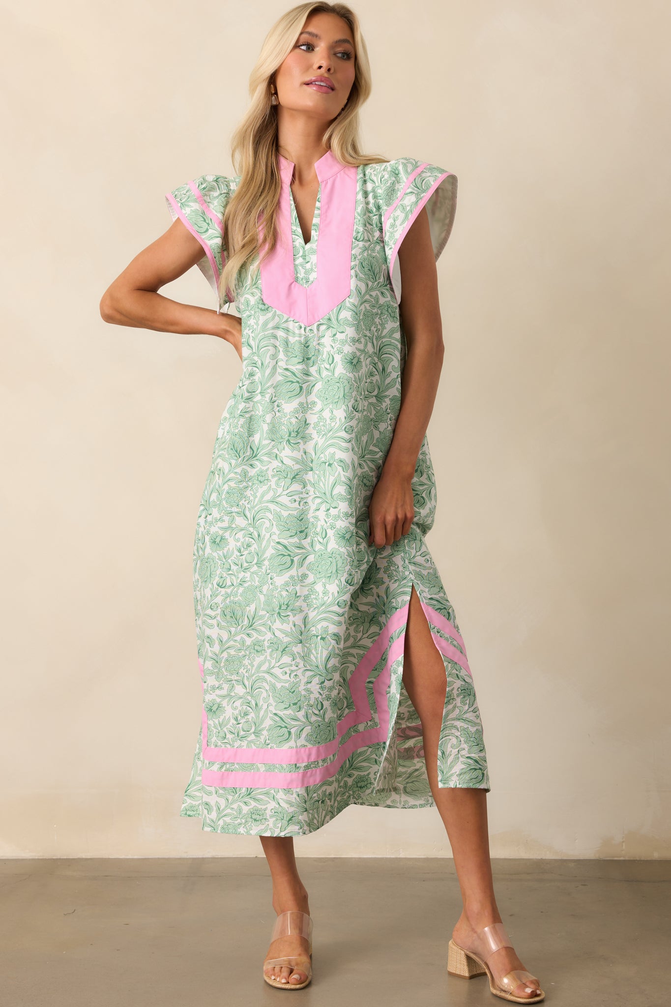 Green floral kaftan dress with a mock v-neckline and relaxed fit, shown in a full front view to highlight the overall silhouette.