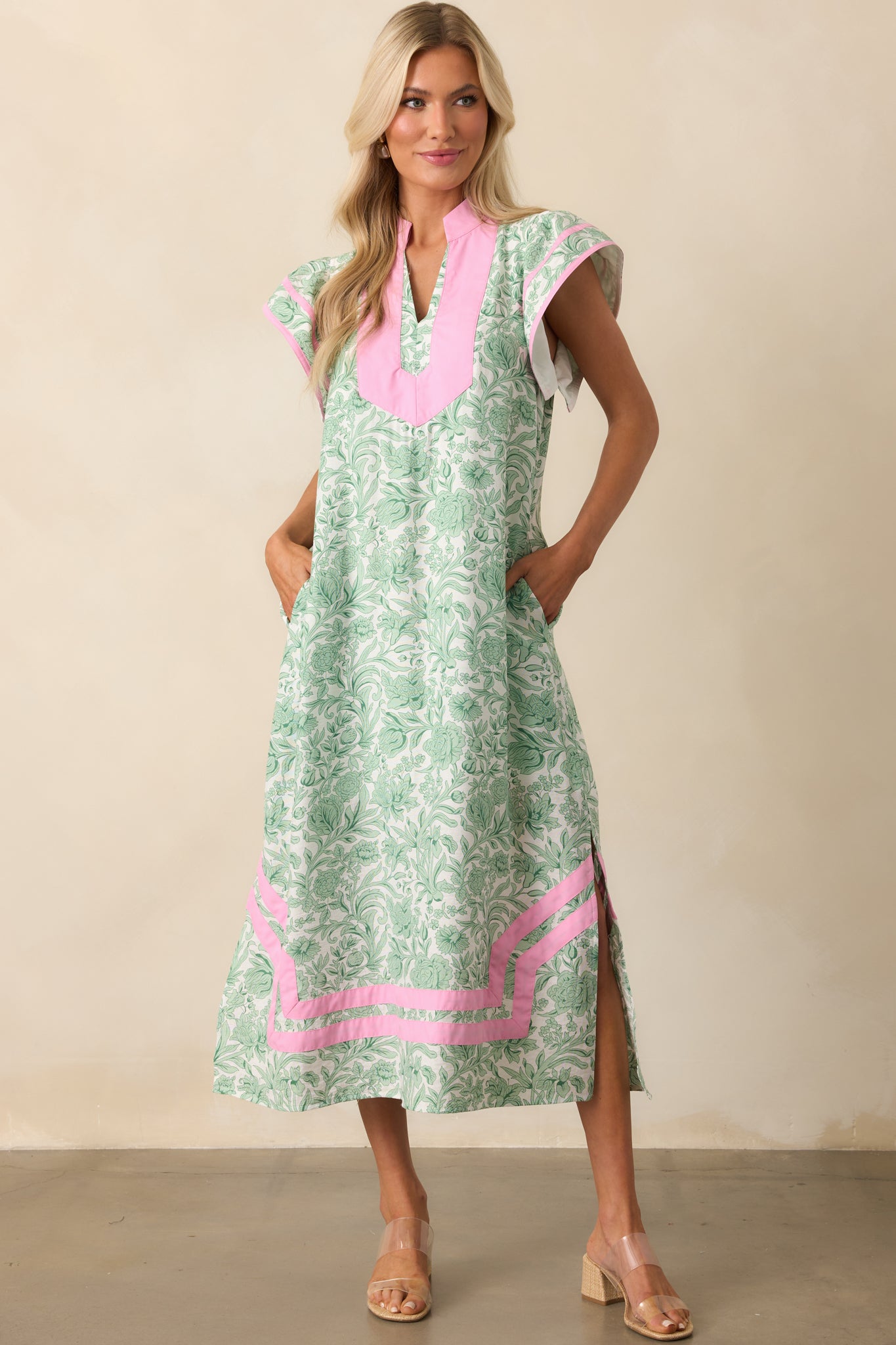Front-facing look at the kaftan dress, focusing on the positioning of the functional pockets and drape of the fabric.