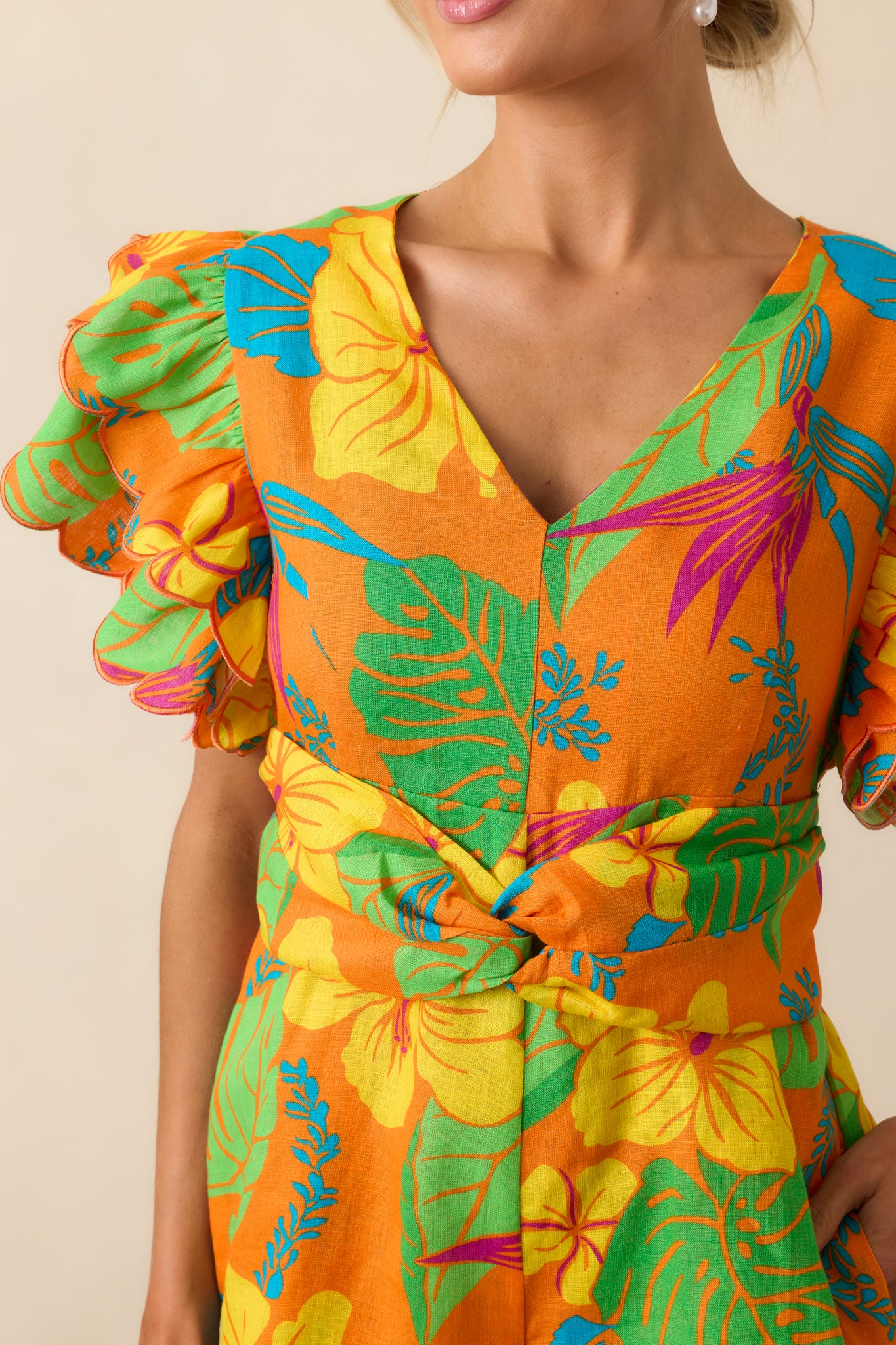 Detail shot of the tropical print on the linen fabric, showing the texture and vibrant color pattern.