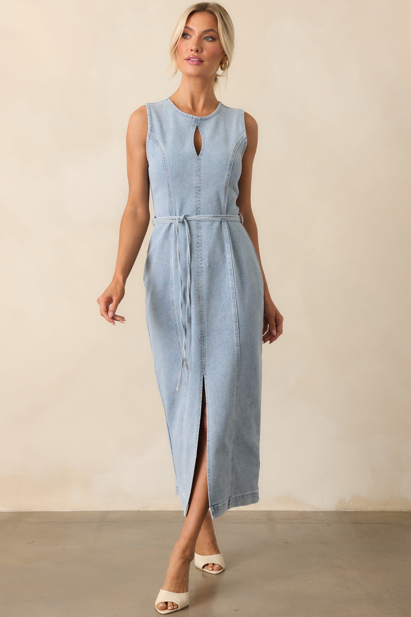 Light blue midi dress in a front-facing shot, highlighting the leg slit and clean, structured lines.