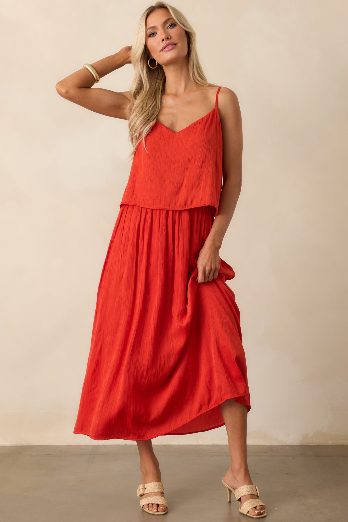 Full view of the red skirt featuring a flowy fit and high-rise silhouette.