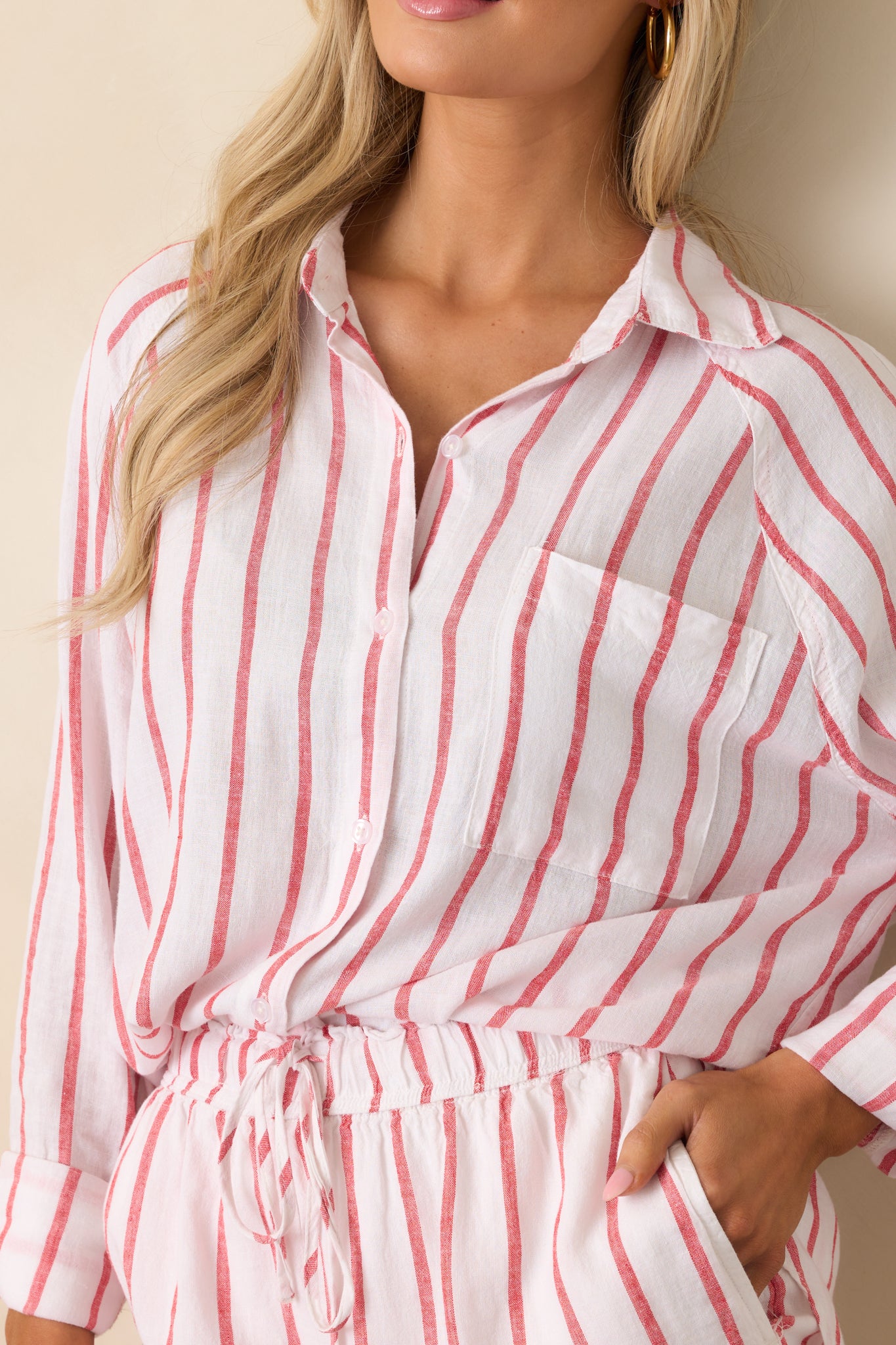 Detailed look at the fabric texture and fine white and red stripes, emphasizing stitching near the collar and placket.