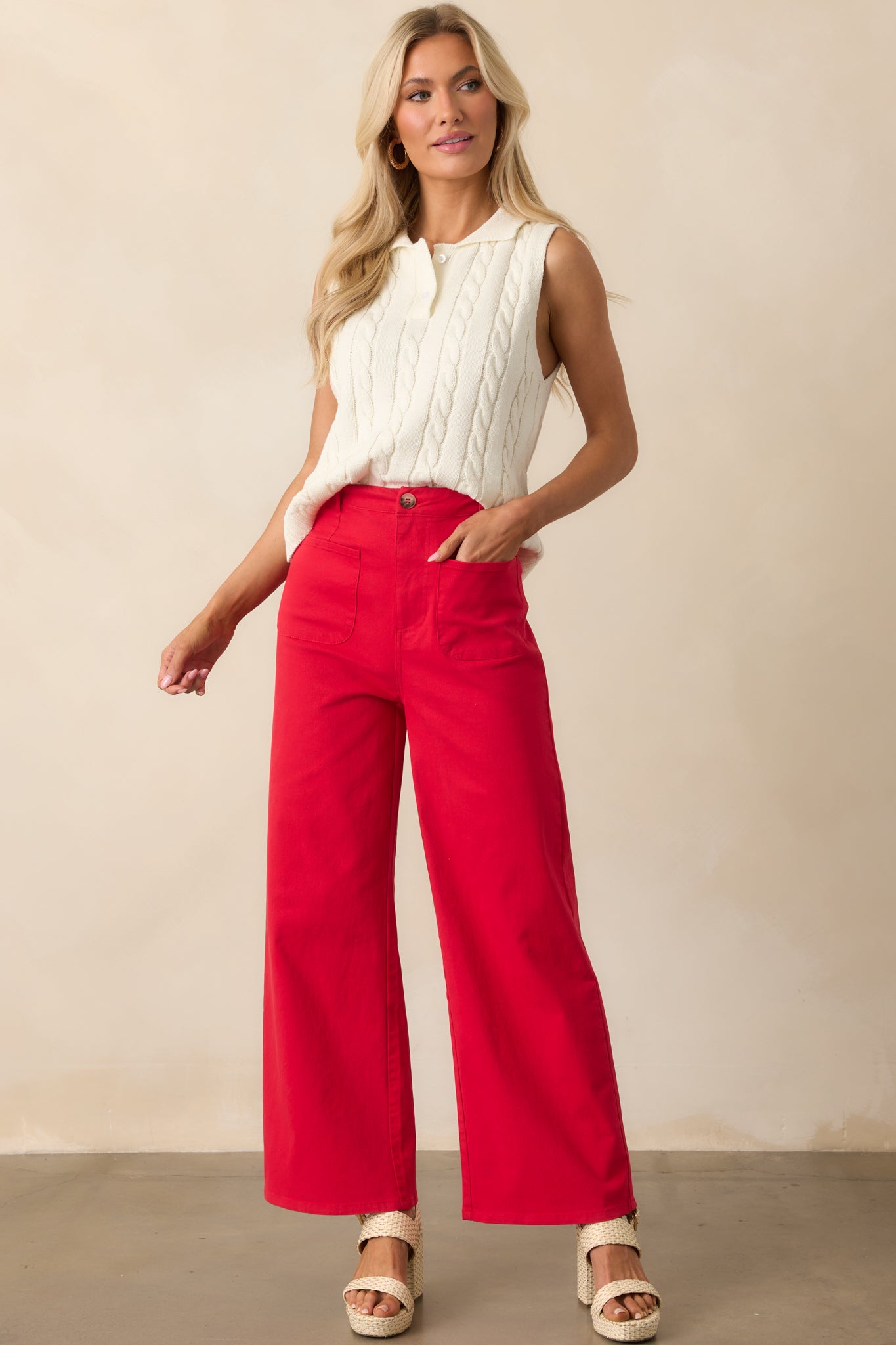 Full-length image capturing the drape of the wide legs and the polished look of the tortoise shell button closure.