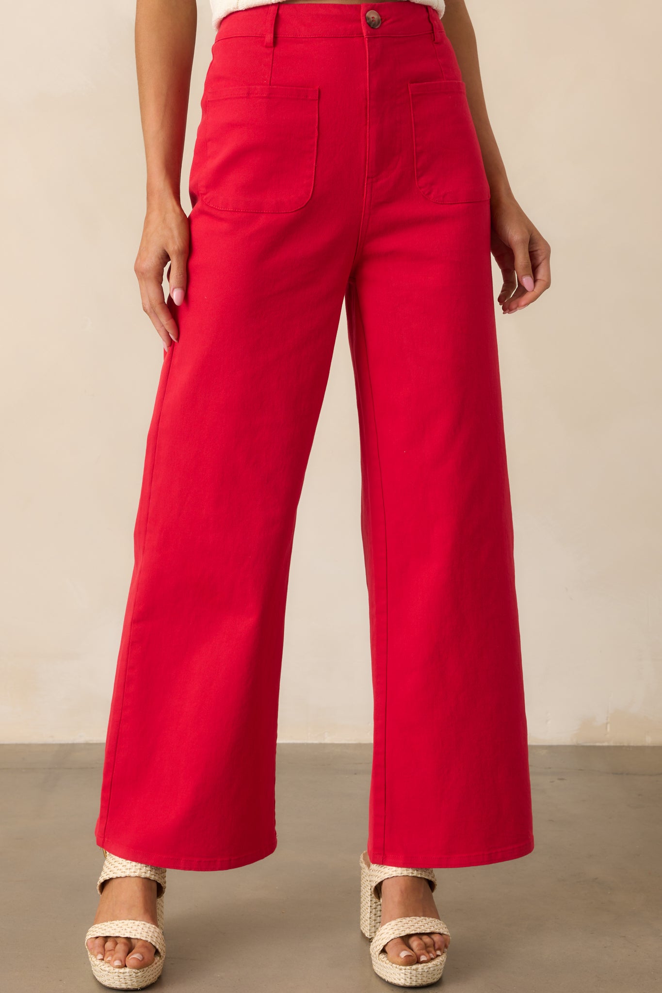 Shot highlighting the wide leg opening and smooth flow of the red fabric.