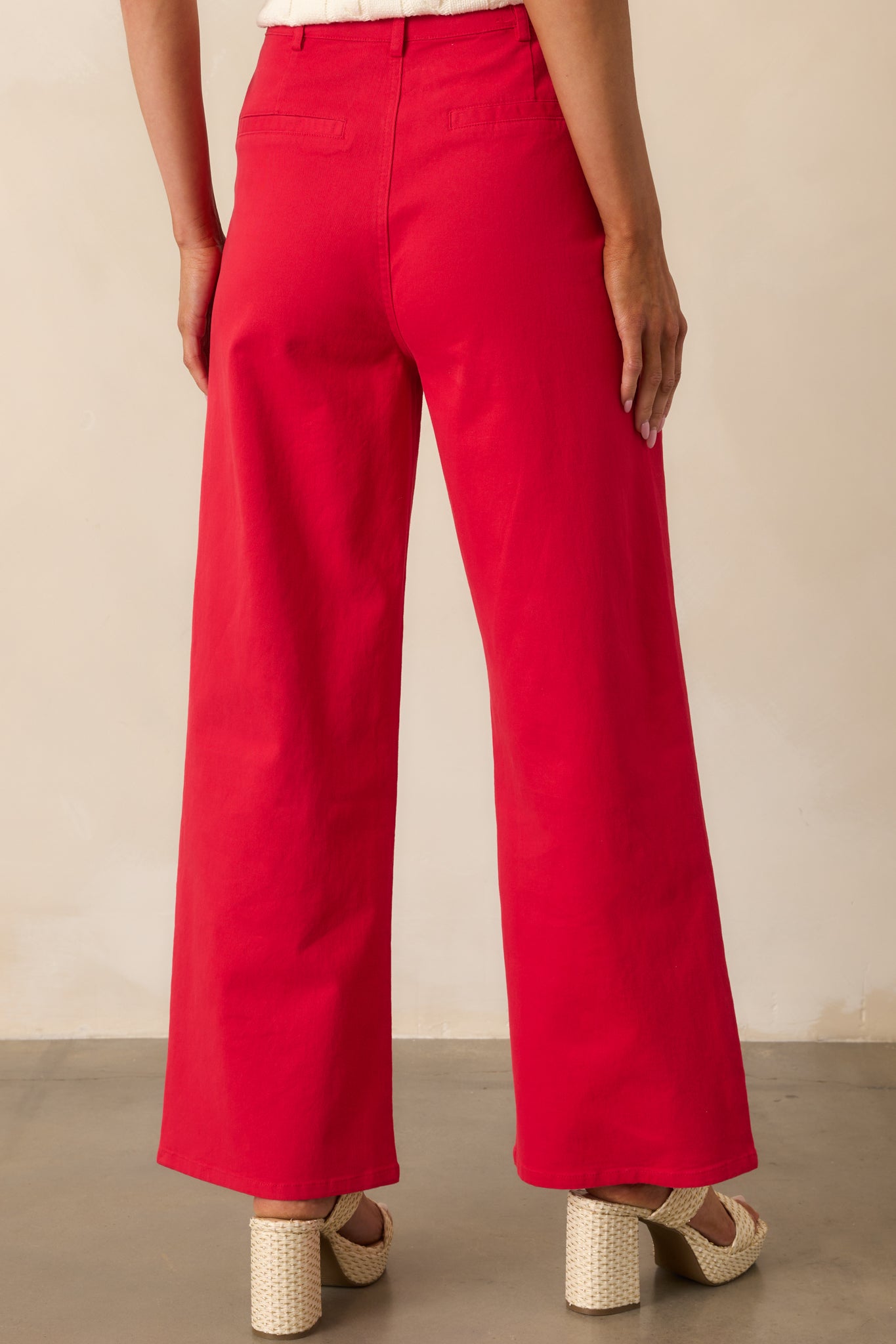 A view from behind showing the non-functional back slit pockets and the wide-leg fit from the rear perspective.