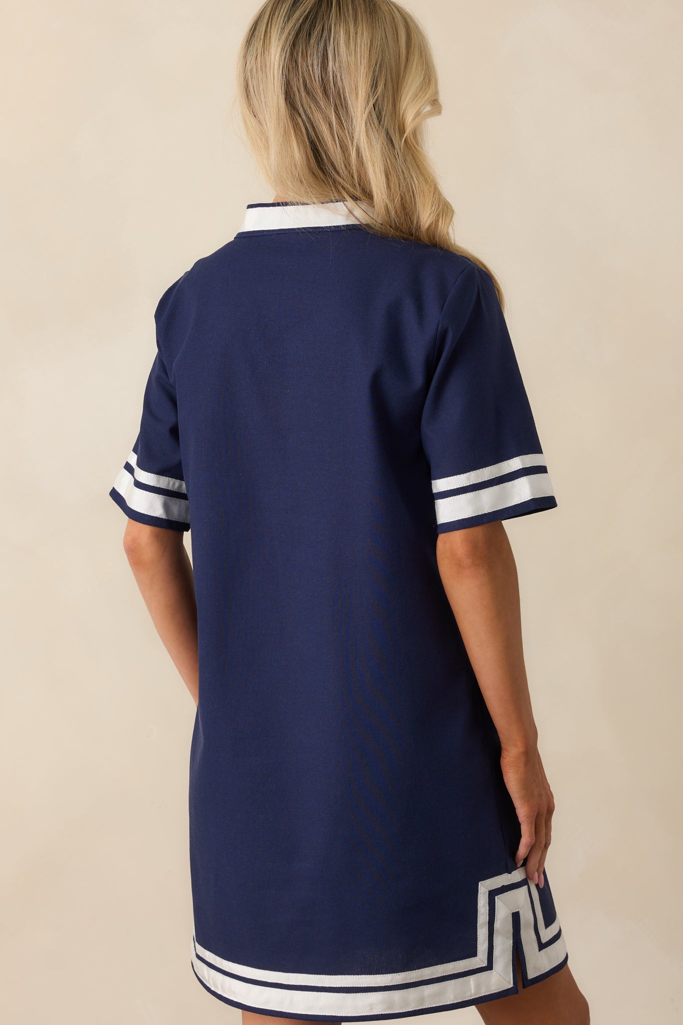 A view from behind showing the clean lines of the shift silhouette and continued contrast trim on the sleeves.