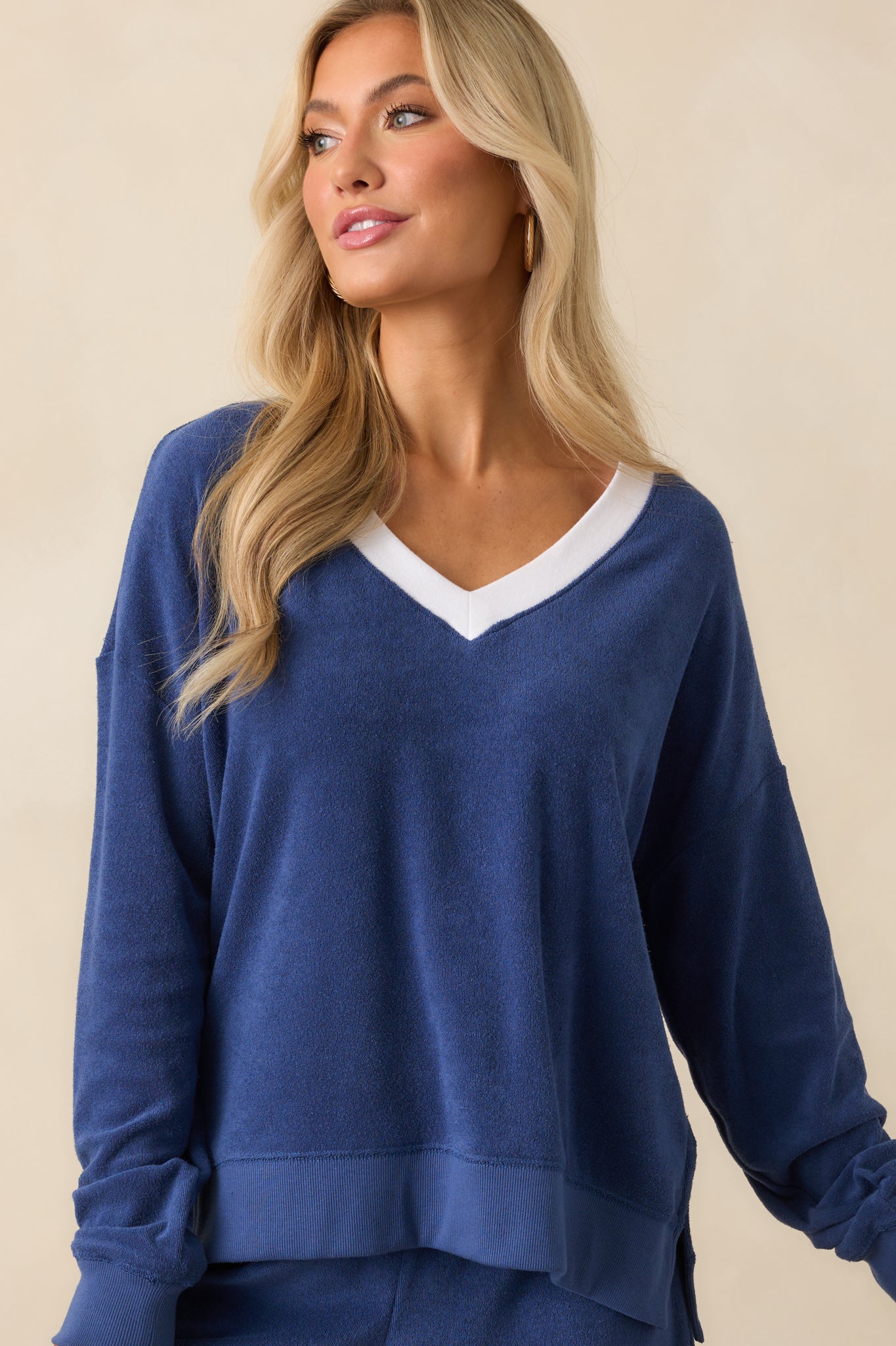 A close cropped image showcasing the ribbed hem and the texture of the terry fabric.