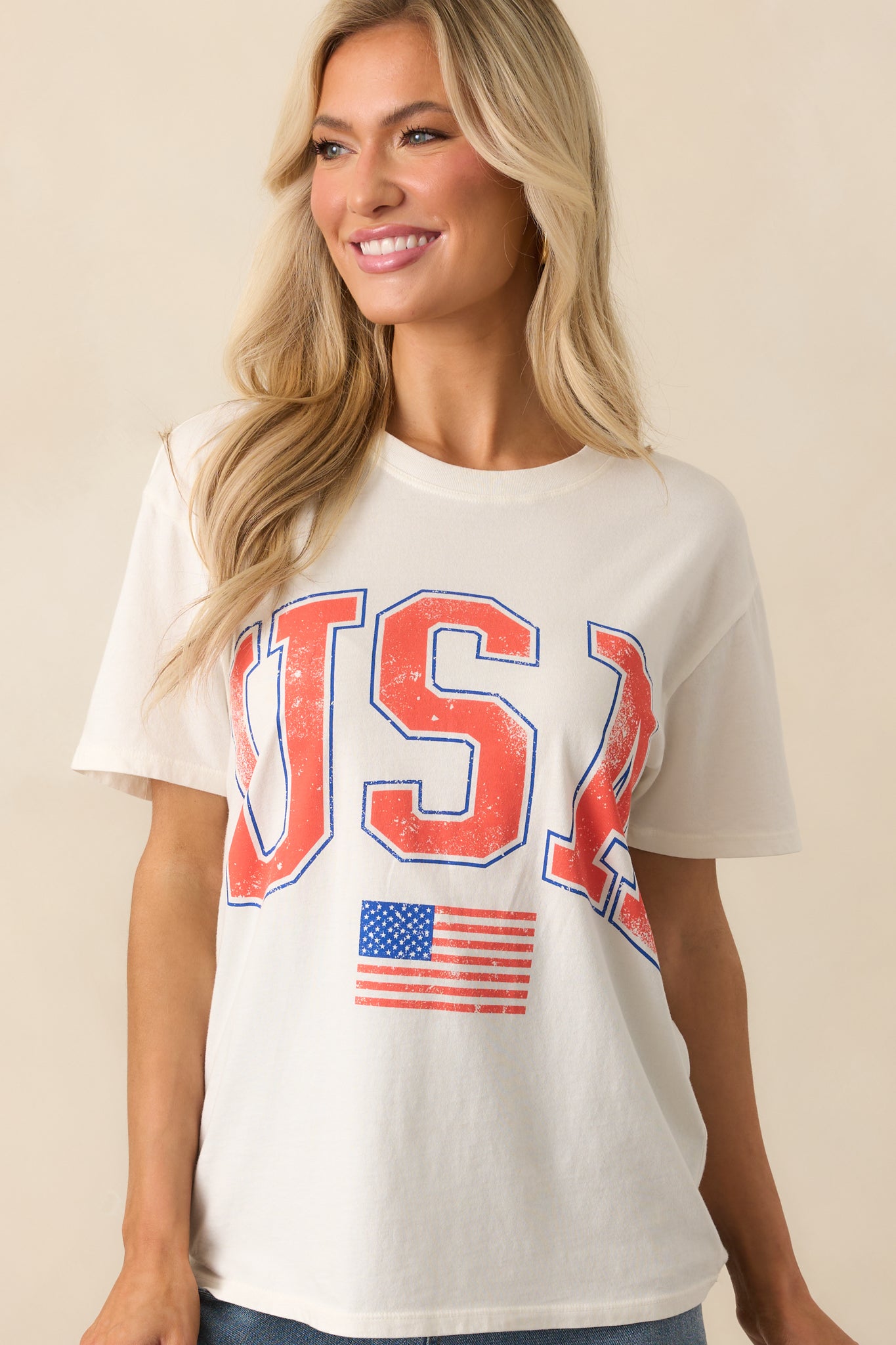 Zoomed-in upper torso shot of the ivory tee highlighting the crew neckline and relaxed drape.