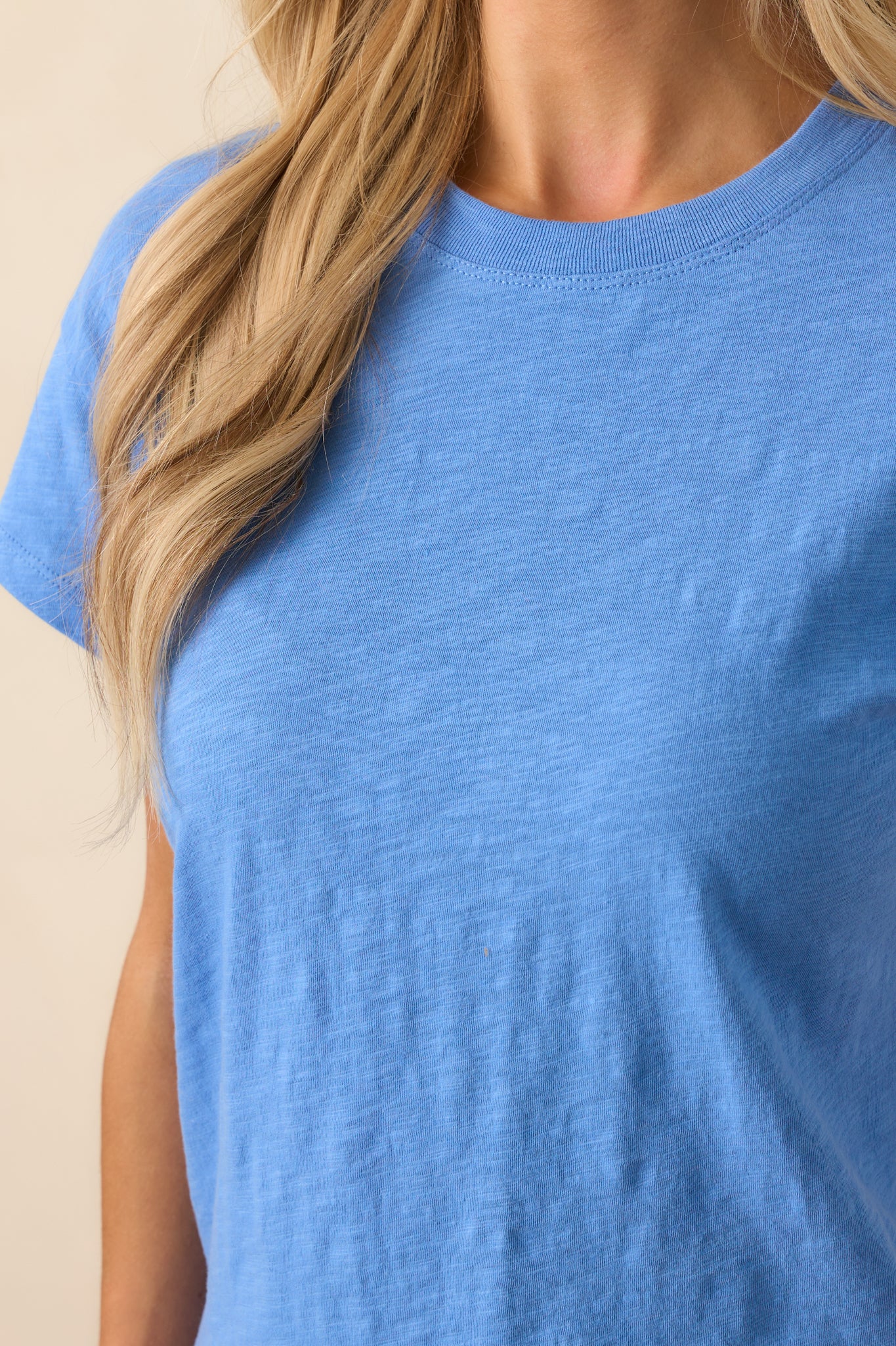A detailed shot of the slub tee highlighting its rich blue hue and smooth surface and fabric.