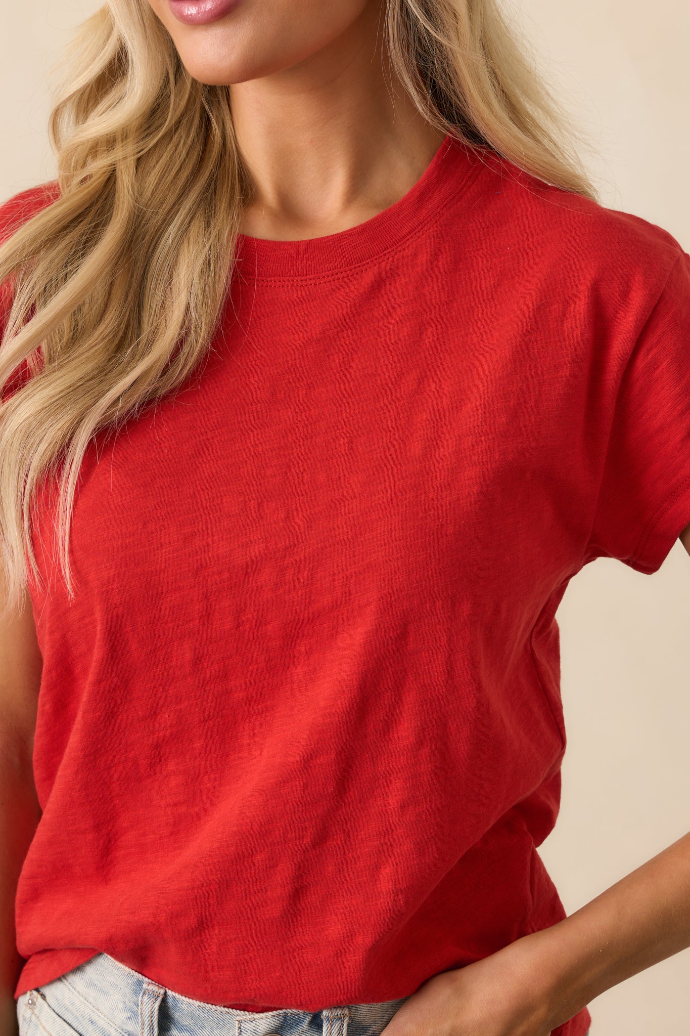 Close-up detail of the red jersey fabric, showing fine-knit texture and stitching quality.