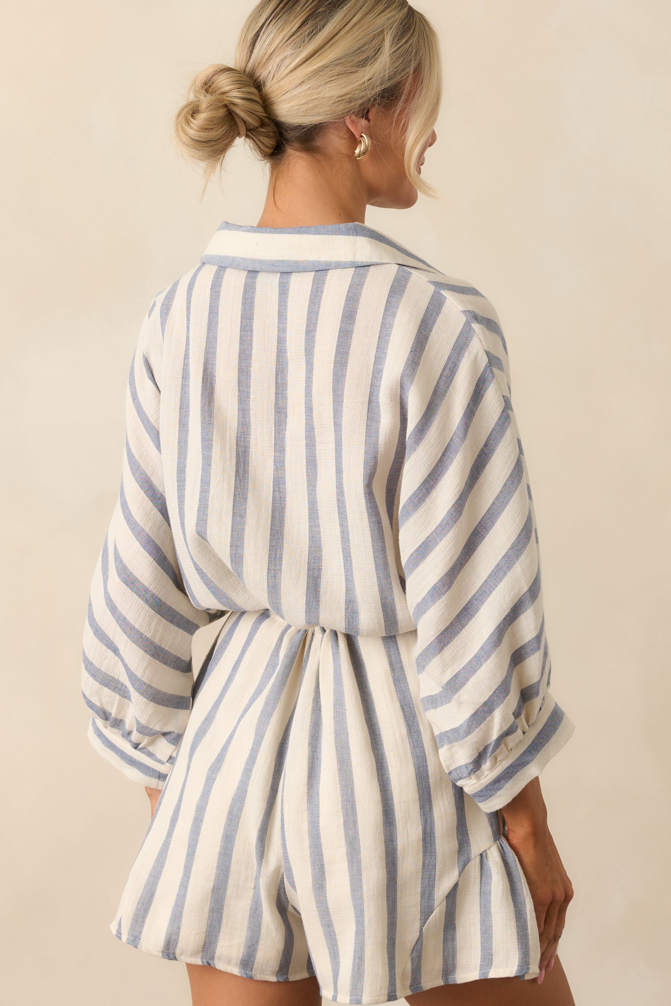 A back view showing the loose fit and stripe alignment across the back and sleeves.