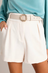 Front view of these shorts that feature a high waisted design, hook and bar closure, zipper, belt loops, and functional pockets in the front.