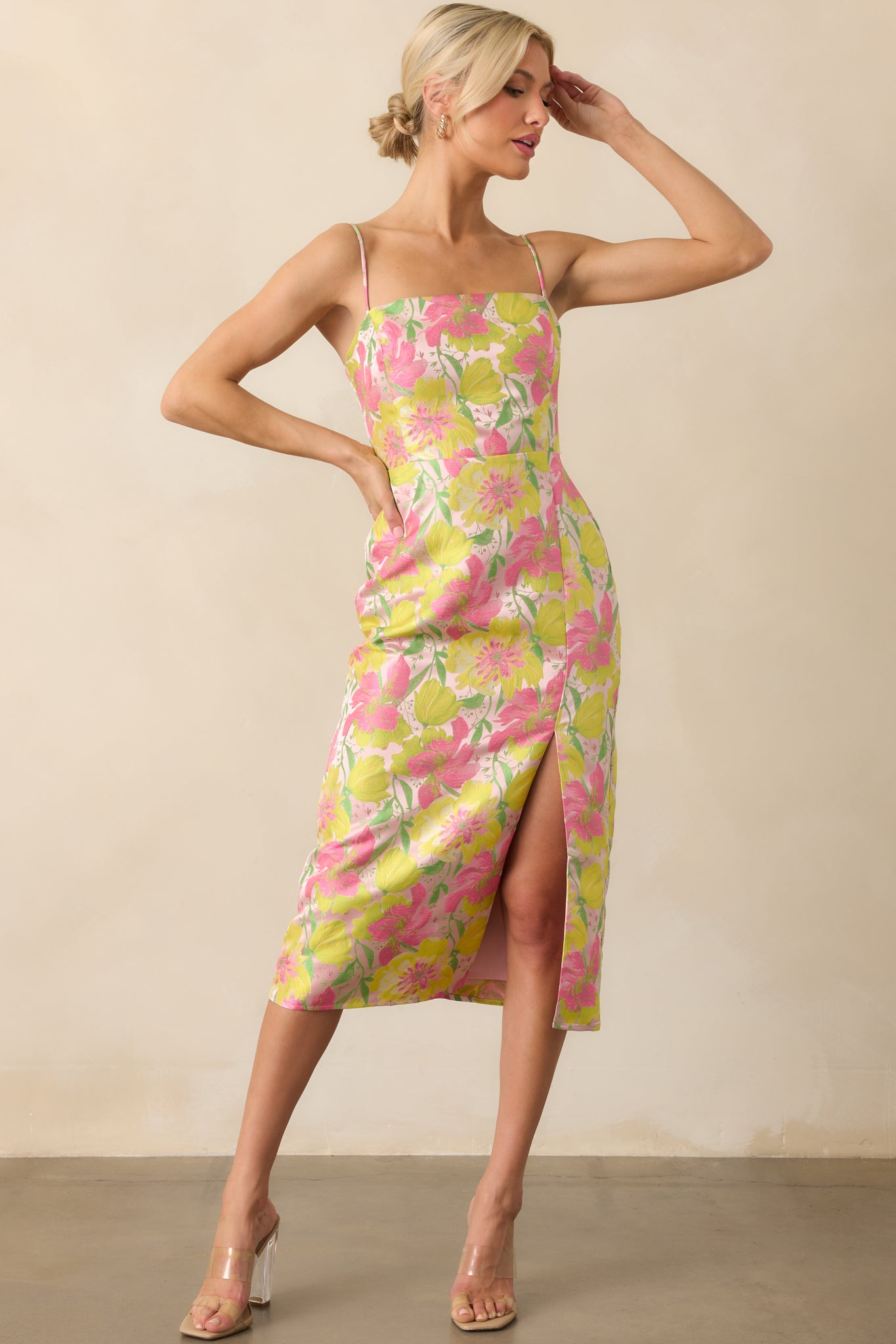 Full body front view of the light pink midi dress showing the bright pink and yellow floral print, square neckline, and adjustable spaghetti straps.