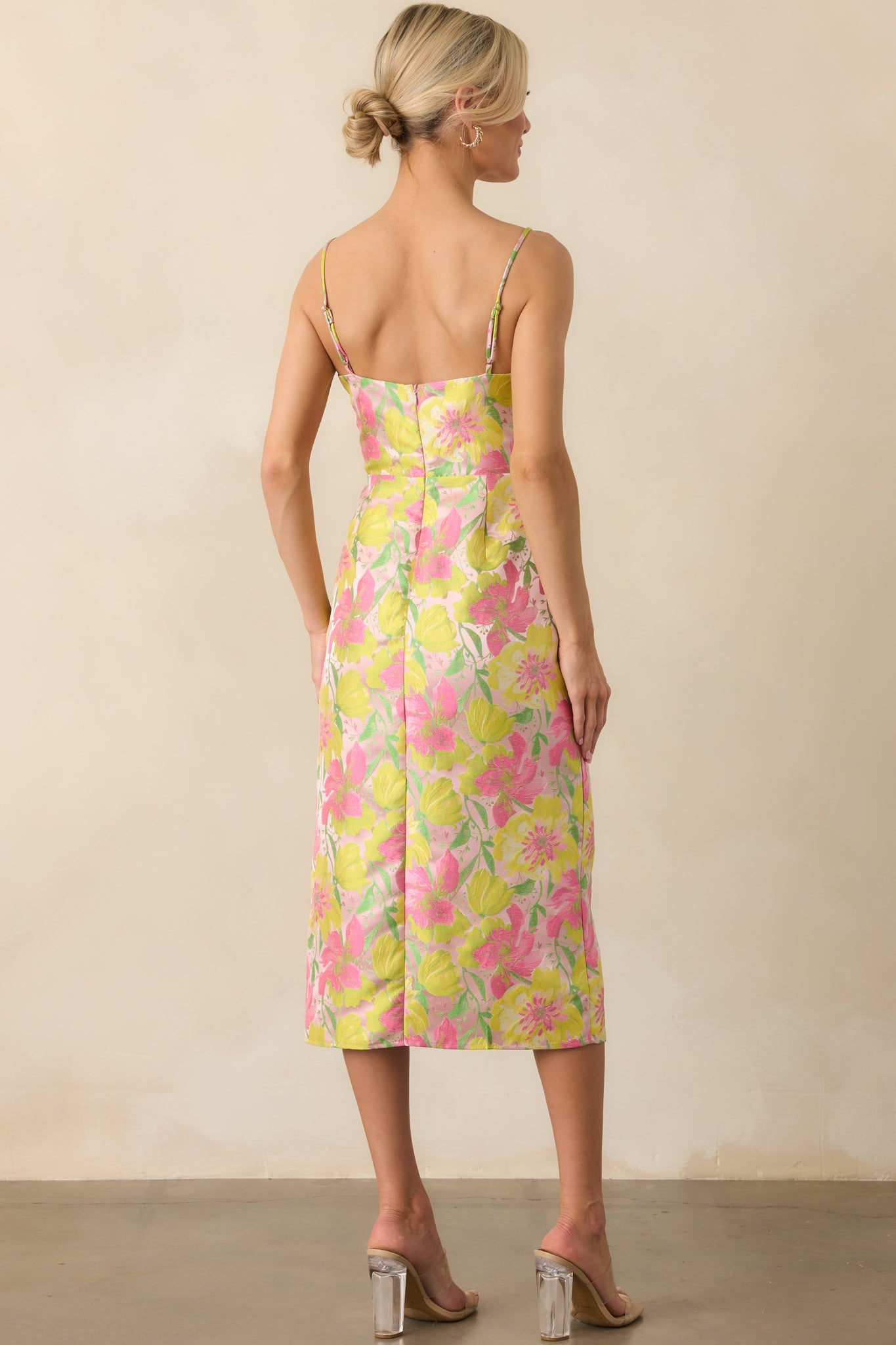 Full back view of the dress showing the adjustable spaghetti straps, hidden zipper closure, and continuation of the floral print across the back.
